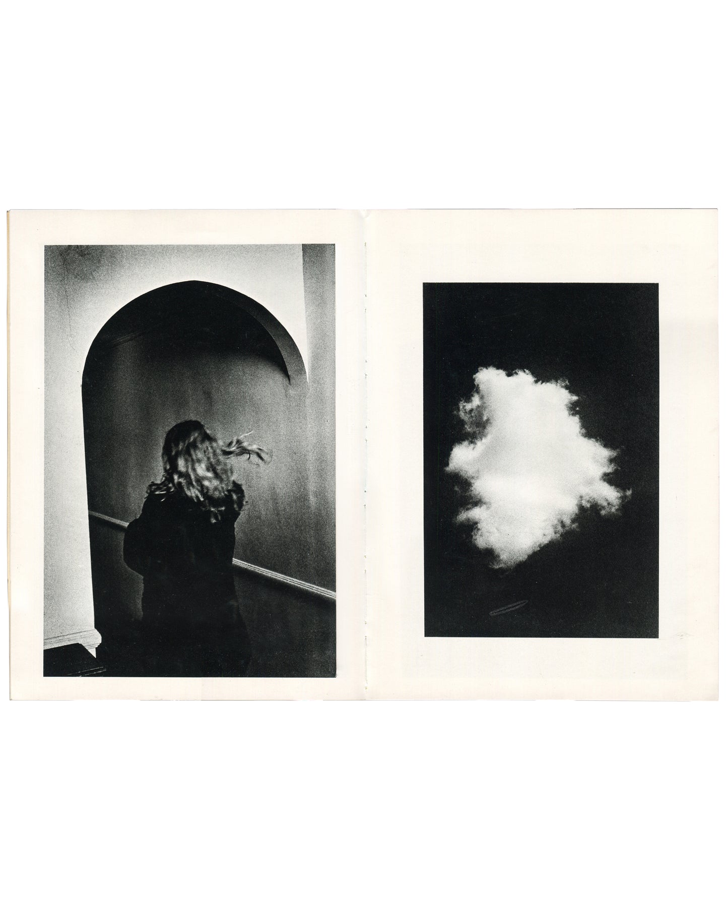  Interior spread of Ralph Gibson, Deja-Vu, Lustrum Press, 1973, left page showing a figure with long hair obscuring their face standing before an arched doorway in high contrast black and white, right page showing a single cloud against a black ground.