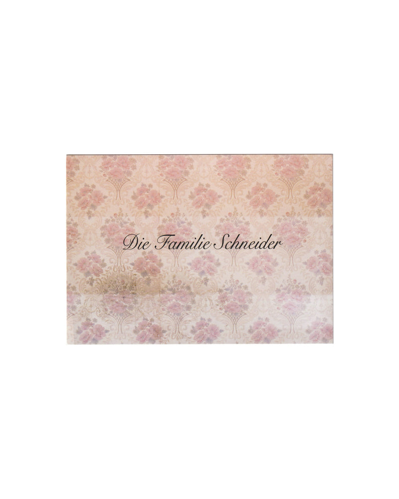 Recto (front):

Gregor Schneider, Die Familie Schneider, Konrad Fischer Galerie, Berlin, 2014. Recto: printed card with repeating soft pink floral wallpaper motif on cream ground; title Die Familie Schneider set in dark script at centre.