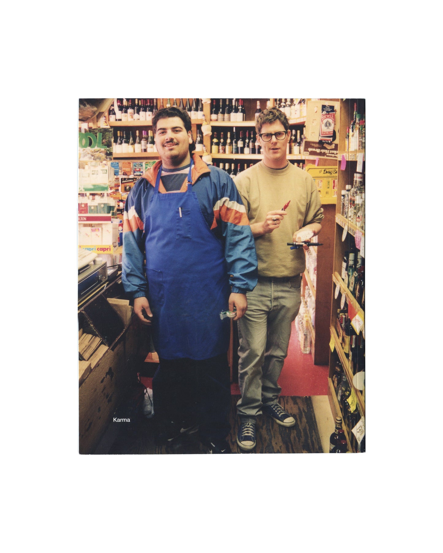 Original 2015 Mark Grotjahn K&H Liquors artist book, Karma, New York. Front cover showing two men standing in a liquor store aisle lined with bottles, with the Karma imprint visible at lower left.