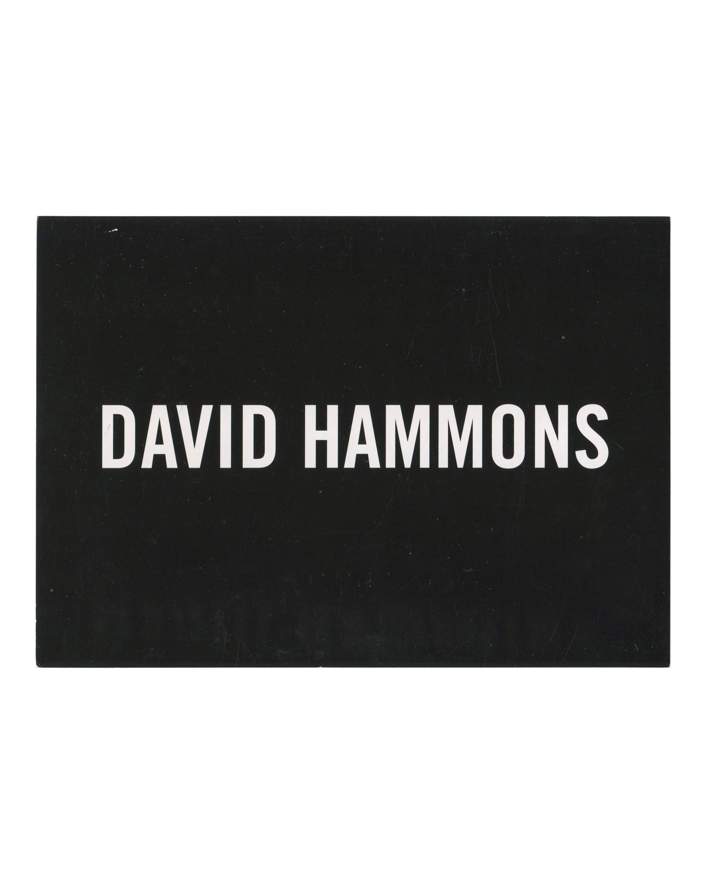 David Hammons, exhibition invitation postcard, L&M Arts, New York, 2011. Recto: white sans-serif text reading DAVID HAMMONS on solid black ground.
