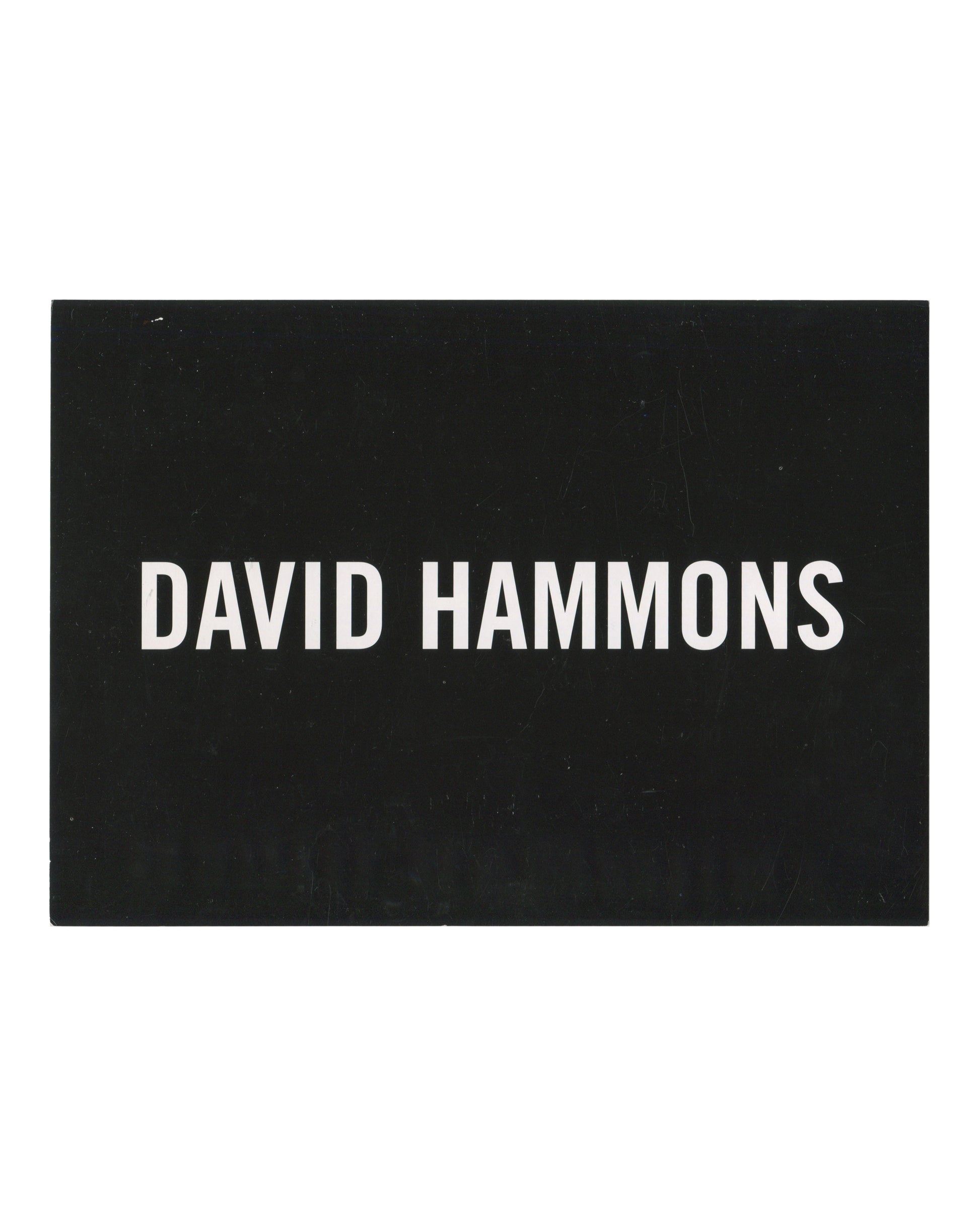 David Hammons, exhibition invitation postcard, L&M Arts, New York, 2011. Recto: white sans-serif text reading DAVID HAMMONS on solid black ground.