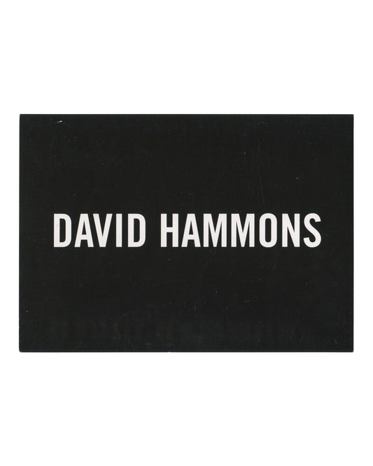 David Hammons, exhibition invitation postcard, L&M Arts, New York, 2011. Recto: white sans-serif text reading DAVID HAMMONS on solid black ground.