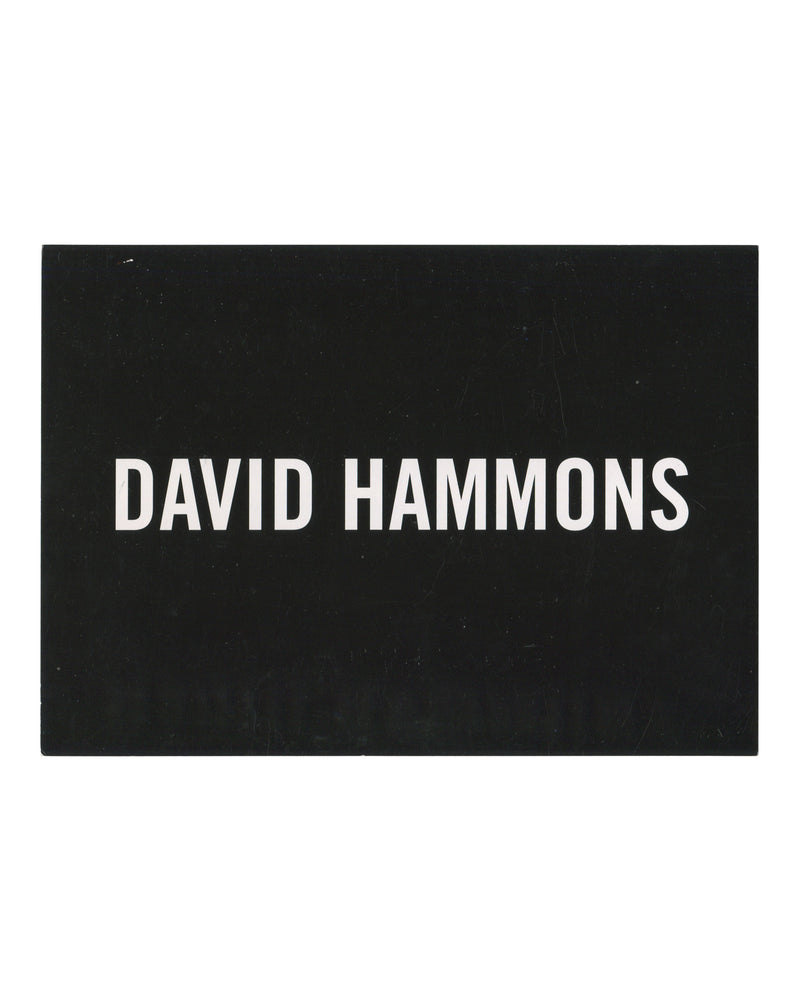 David Hammons, exhibition invitation postcard, L&M Arts, New York, 2011. Recto: white sans-serif text reading DAVID HAMMONS on solid black ground.