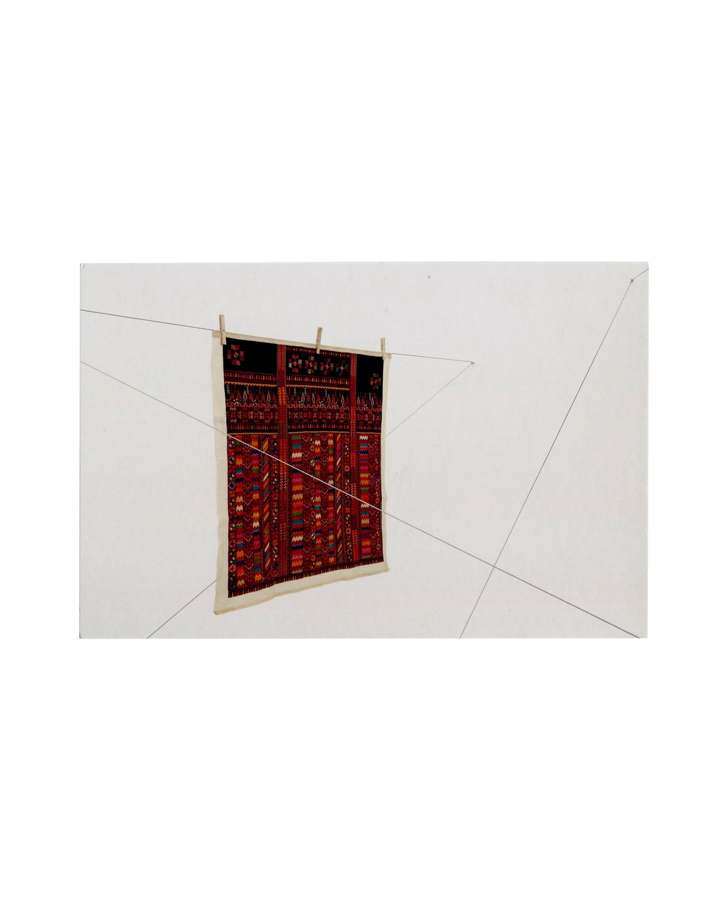 Mona Hatoum, Twelve Windows 2012–13; single Palestinian embroidery panel on clothes pegs, steel cables crossing white gallery wall