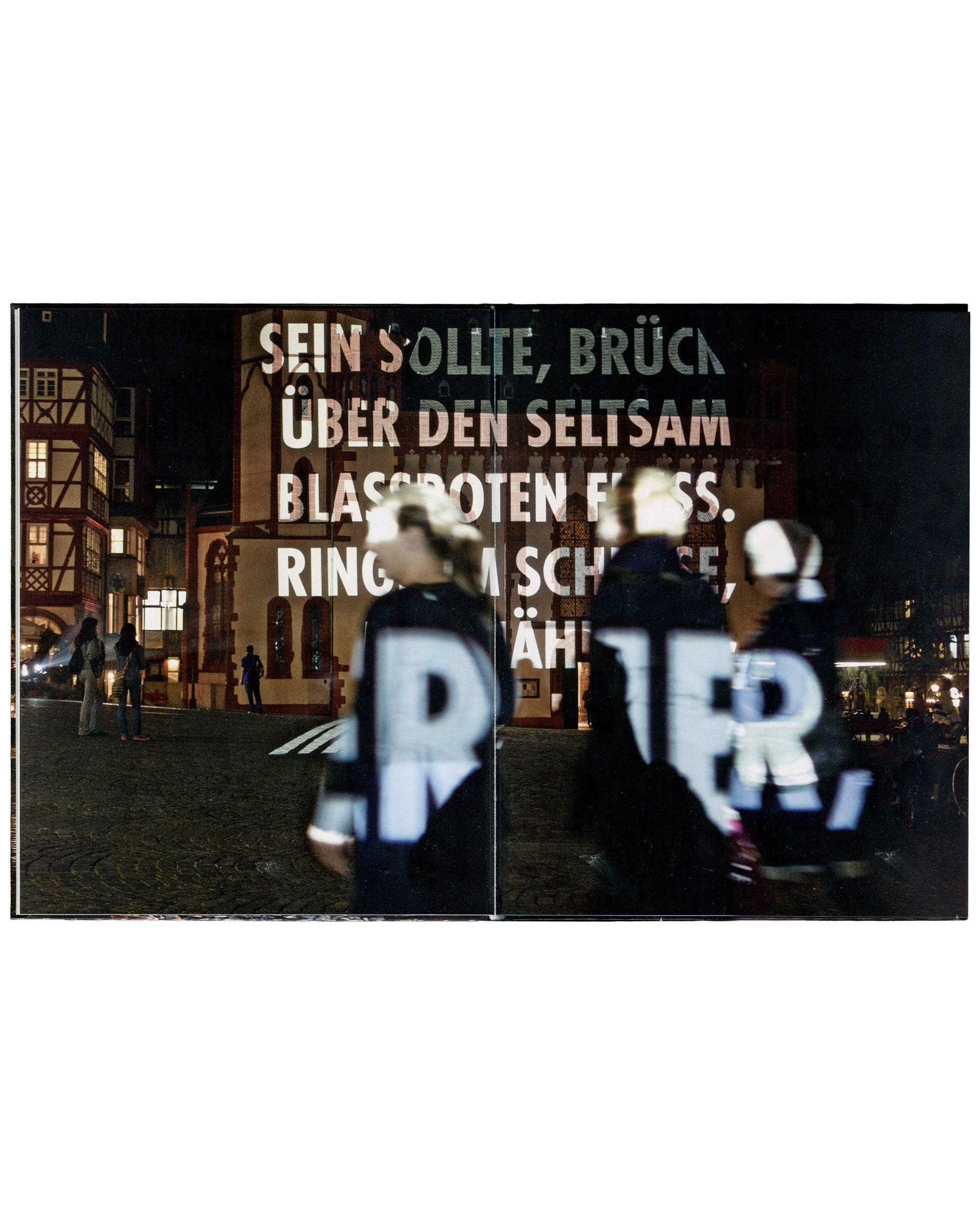 Jenny Holzer, For Frankfurt, 2011, interior spread, text projection on Frankfurt building, pedestrians in foreground.