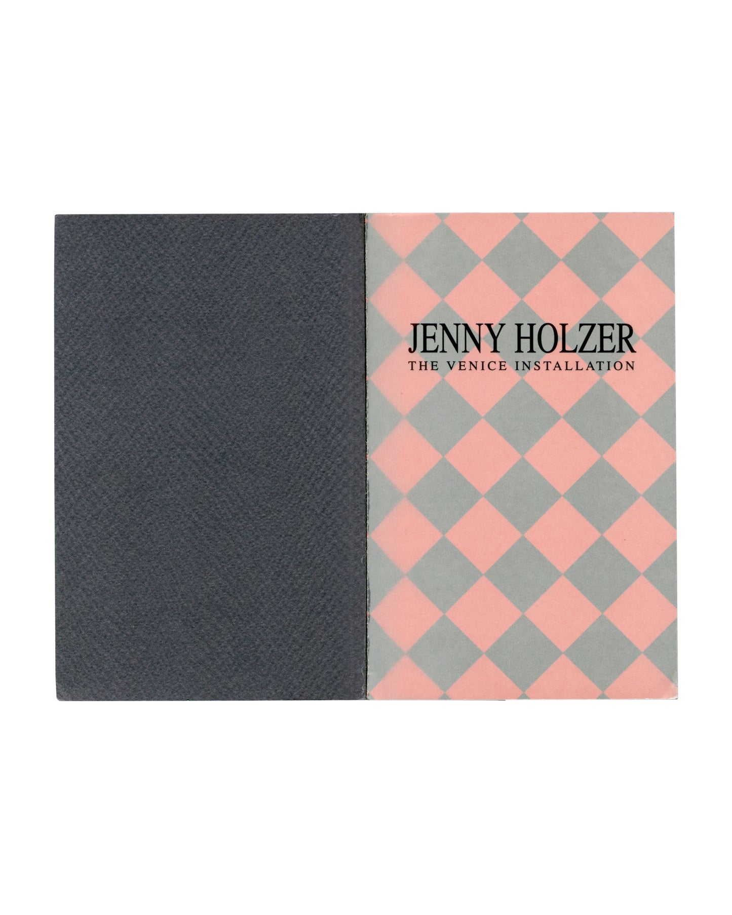 nterior spread: dark grey left page, pink and grey diamond-patterned right page with title in black