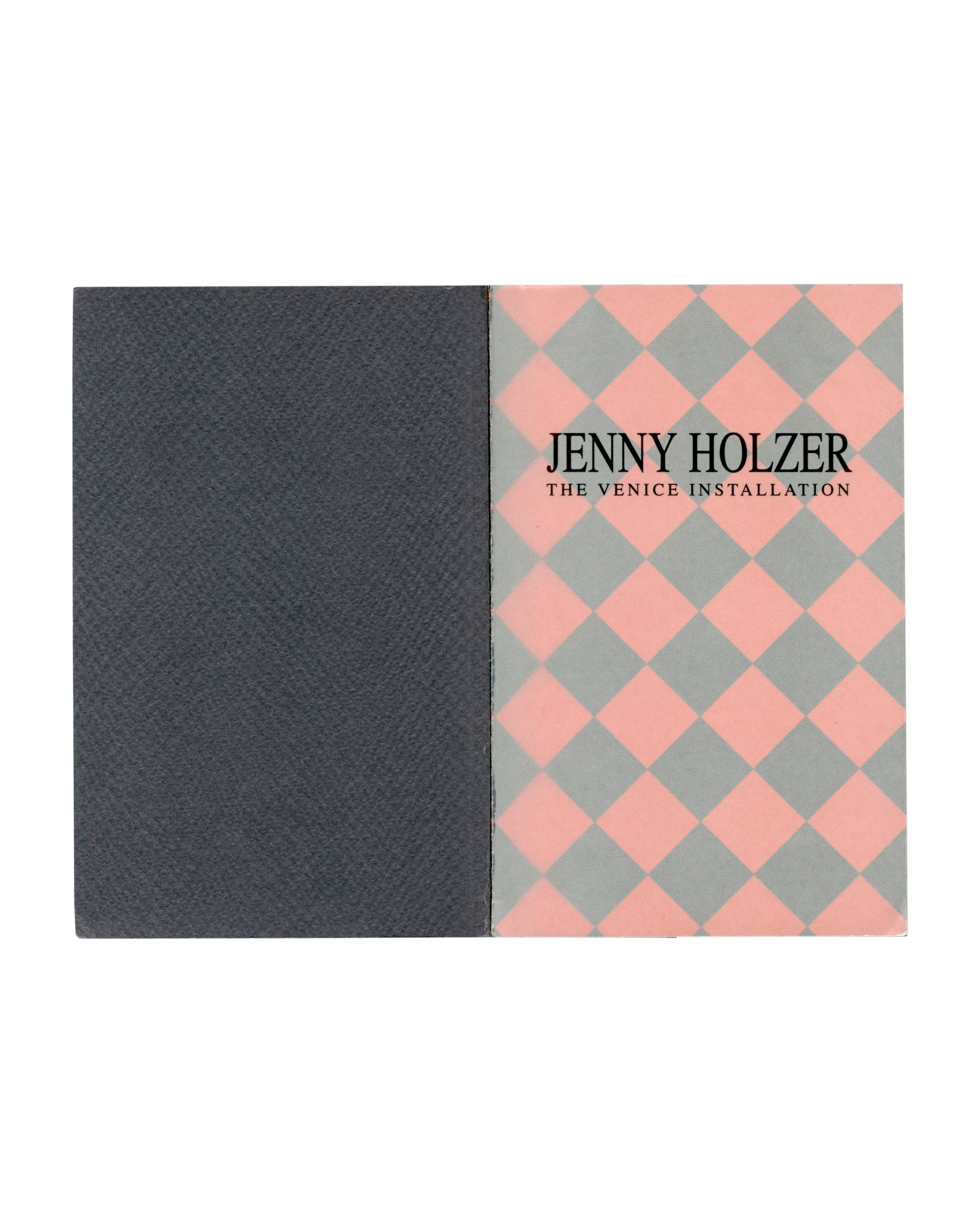 nterior spread: dark grey left page, pink and grey diamond-patterned right page with title in black