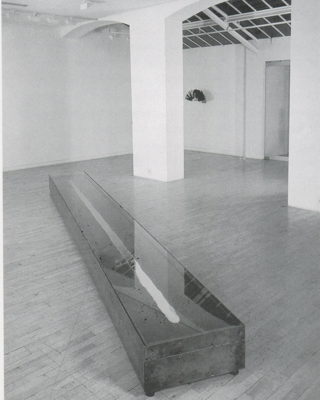Rebecca Horn, Overtura 1973, interior spread: low glass vitrine with ink-splattered surface, mercury traces, Tate Gallery handout 1994