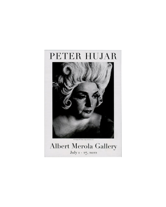 Verso — reclining figure with flower Peter Hujar, Vintage, Albert Merola Gallery, Provincetown, 2022. Announcement verso: monochrome photograph of a reclining figure in heavy eye makeup, pearl necklace and dark clothing, holding a flower to their lips, head tilted back; 'PETER HUJAR' in large serif caps above image; 'Vintage' in italic below name; subtitle 'Uncomplicated, direct photographs of complicated and difficult subjects' in small italic; 'Albert Merola Gallery / 424 Commercial Street Provincetown / 