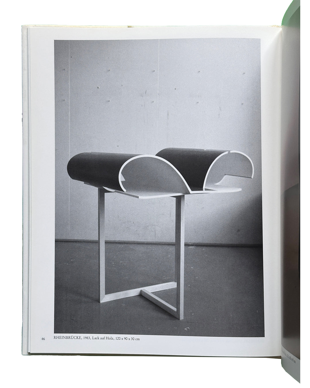  Interior spread: Isa Genzken — Rheinbrücke, 1983, Lack auf Holz, 120 x 90 x 30 cm — black and white photograph of lacquered wood sculpture on metal stand, two curved cylindrical forms