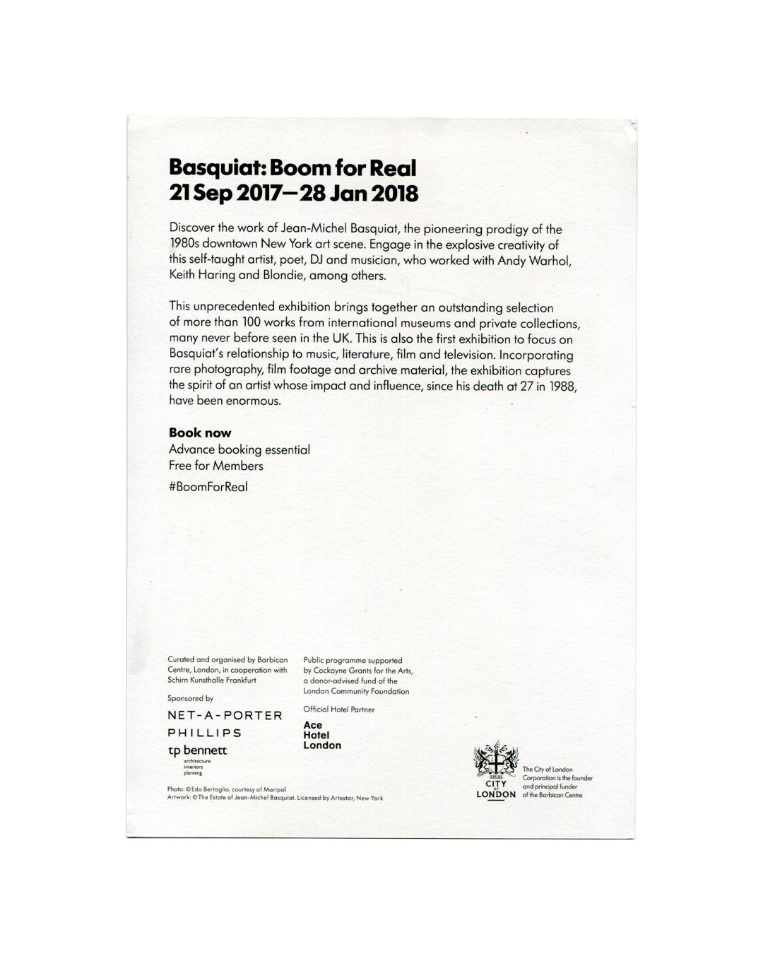 Promotional card verso, Jean-Michel Basquiat: Boom for Real, Barbican Art Gallery, London, 2017. White ground. Bold black sans-serif header — 'Basquiat: Boom for Real / 21 Sep 2017—28 Jan 2018'. Two paragraphs of exhibition text describing Basquiat as 'pioneering prodigy of the 1980s downtown New York art scene' and noting 100+ works from international collections. Bold text: 'Book now / Advance booking essential / Free for Members / #BoomForReal'. Lower section: institutional credits — curated by Barbican 