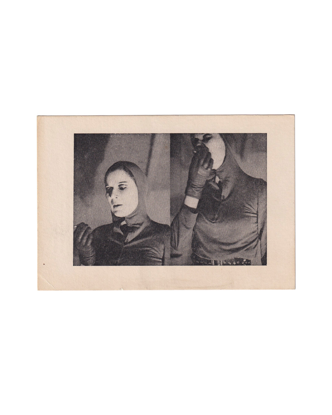 Front of a small 1973 Katharina Sieverding artist card showing a black-and-white double portrait of the artist in a tight hood and gloves, one figure facing down and the other holding a round mirror over the face, printed within a wide cream border.