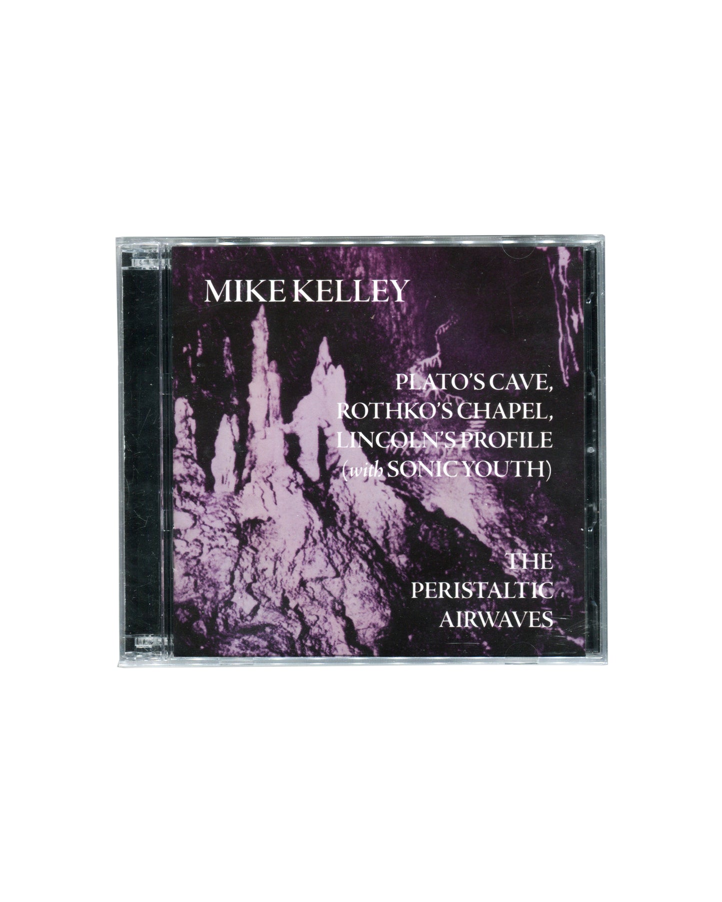 Mike Kelley Plato’s Cave, Rothko’s Chapel, Lincoln’s Profile (with Sonic Youth) / The Peristaltic Airwaves (2012) double CD in sealed jewel case. Purple-toned cover image featuring cave-like formations with white typography. Published by Compound Annex Records.