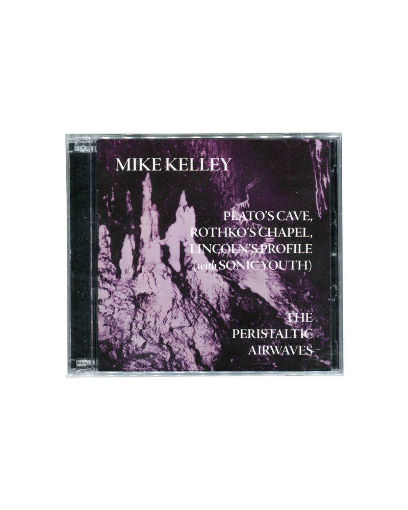 Mike Kelley Plato’s Cave, Rothko’s Chapel, Lincoln’s Profile (with Sonic Youth) / The Peristaltic Airwaves (2012) double CD in sealed jewel case. Purple-toned cover image featuring cave-like formations with white typography. Published by Compound Annex Records.