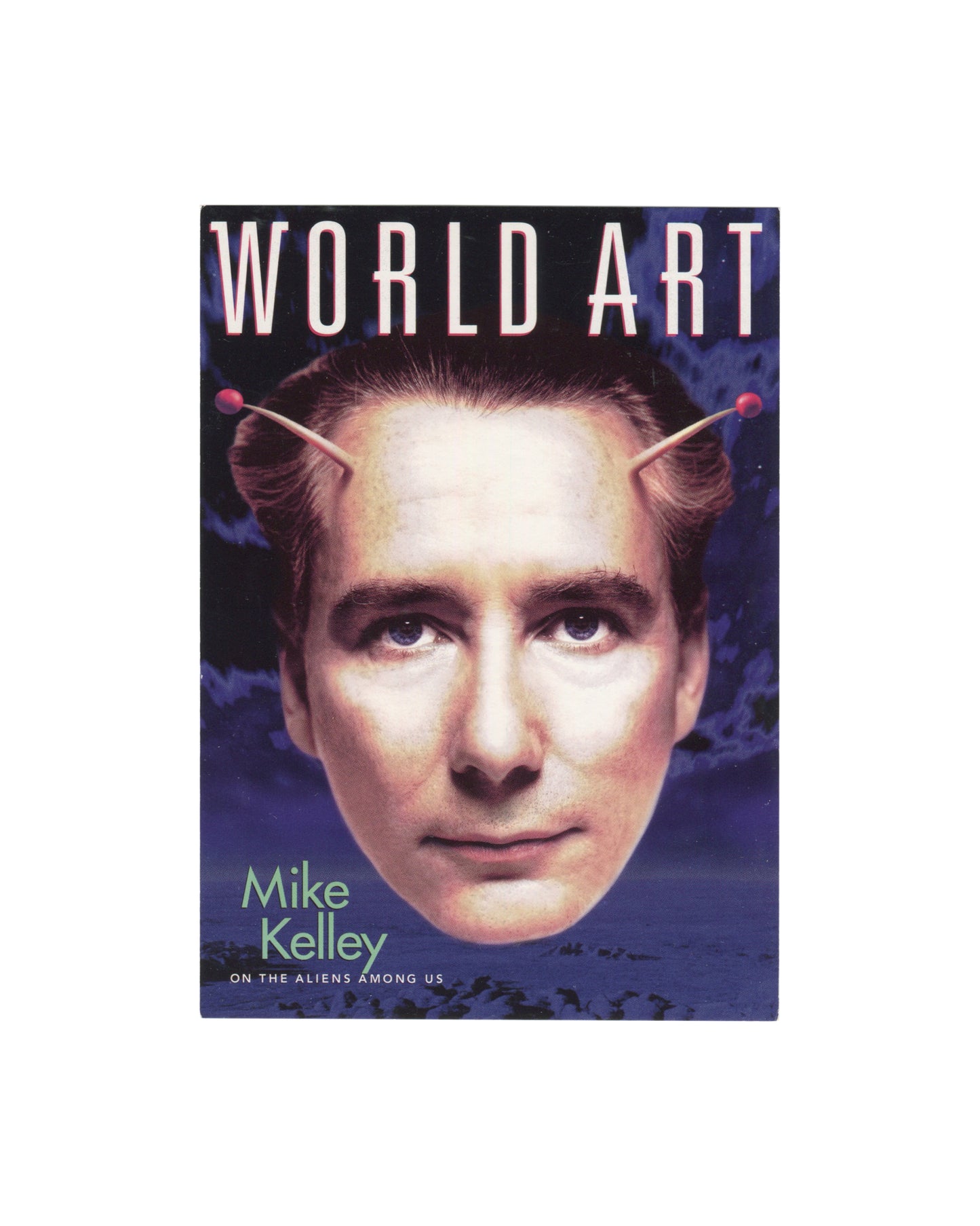 Front Original c. 2000–2001 Mike Kelley World Art magazine GoCard promotional postcard, front, showing the magazine cover with a digitally composited colour image of a man's face with stylised pink antennae rising from his temples against a dramatic purple and blue clouded sky, with the masthead WORLD ART in large white outlined capitals at top and the text Mike Kelley / ON THE ALIENS AMONG US in white and pale green type at lower left.