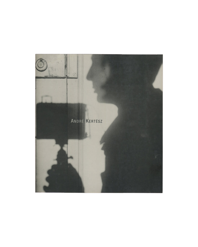 Black-and-white softcover catalogue titled André Kertész. The cover features a blurred self-portrait-like silhouette reflected against a doorway, with the photographer's name printed across the centre.