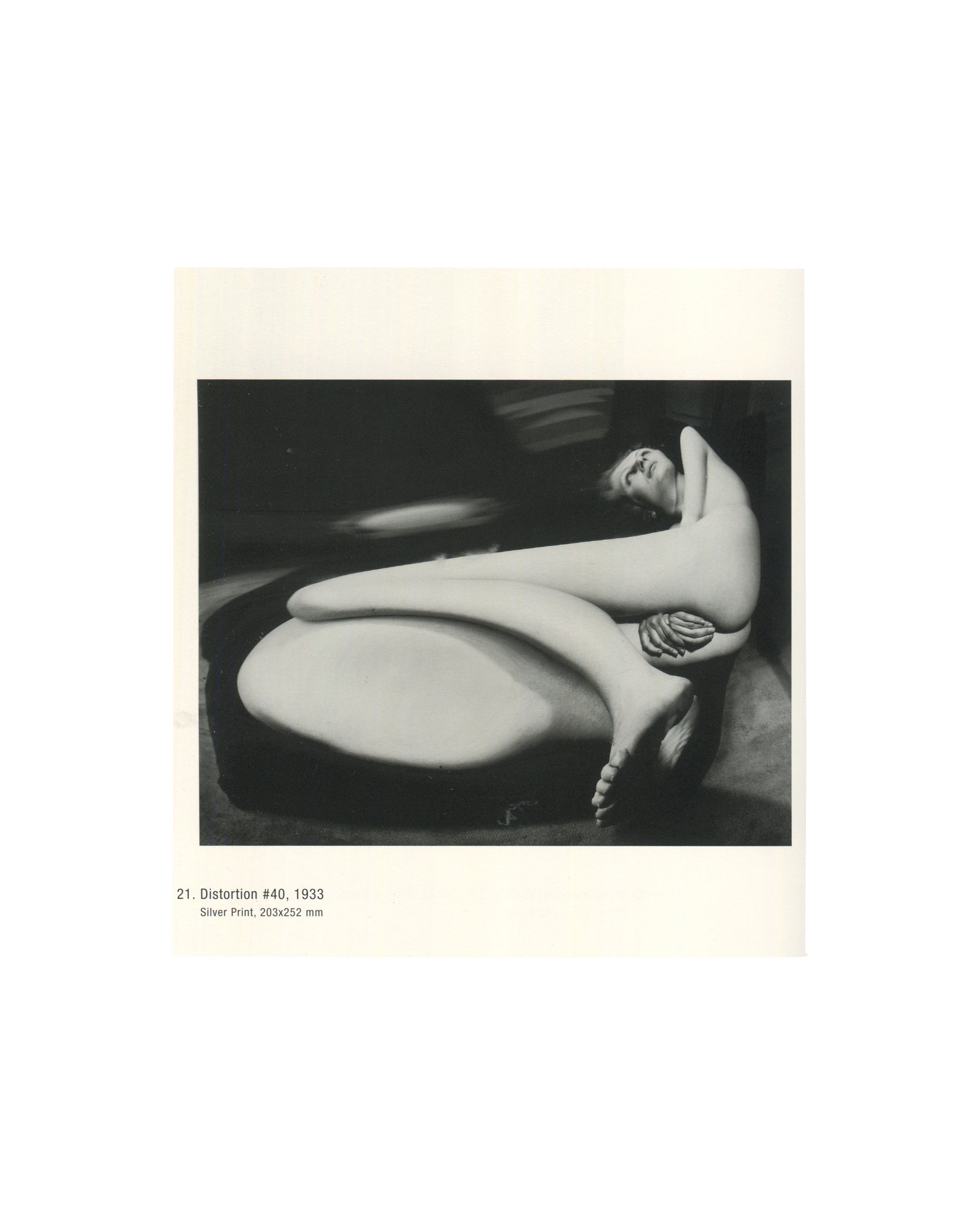 Kertész's famous Distortion #40 (1933), depicting a reclining nude figure stretched and transformed through a distorted mirror.
