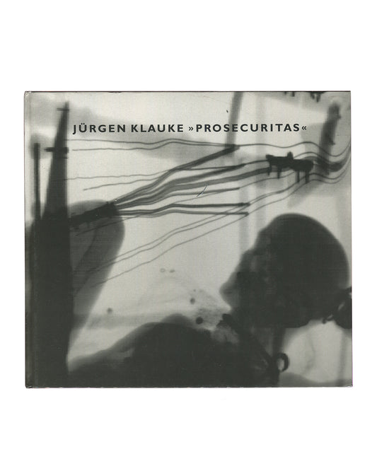 Original 1994 Jürgen Klauke Prosecuritas exhibition catalogue. Front cover showing a black-and-white scanned or photocopied image: two small dog silhouettes walk across a pale ground trailing long curved lines, while large dark shadowy forms — a vertical pole left and a crouching figure lower right — dominate the foreground. Title 'JÜRGEN KLAUKE »PROSECURITAS«' in small spaced sans-serif type upper centre. Square format, cloth-bound hardcover with clear plastic dust jacket.