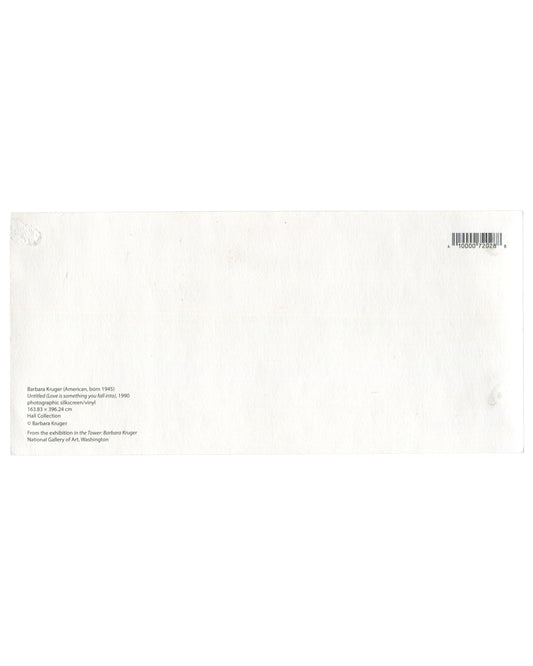 Reverse side of a Barbara Kruger exhibition postcard with small black text on white card stock identifying Untitled (Love is something you fall into) (1990), materials and dimensions, Hall Collection credit, and publication information from In the Tower: Barbara Kruger at the National Gallery of Art, Washington. Barcode at upper right with light handling wear and adhesive residue visible.