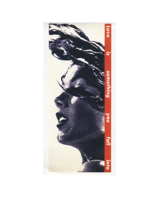 Artist postcard reproducing Barbara Kruger’s Untitled (Love is something you fall into) (1990). A tightly cropped black-and-white profile of a woman with windswept hair fills the card while a vertical red banner runs along the right side with white text reading: “Love is something you fall into