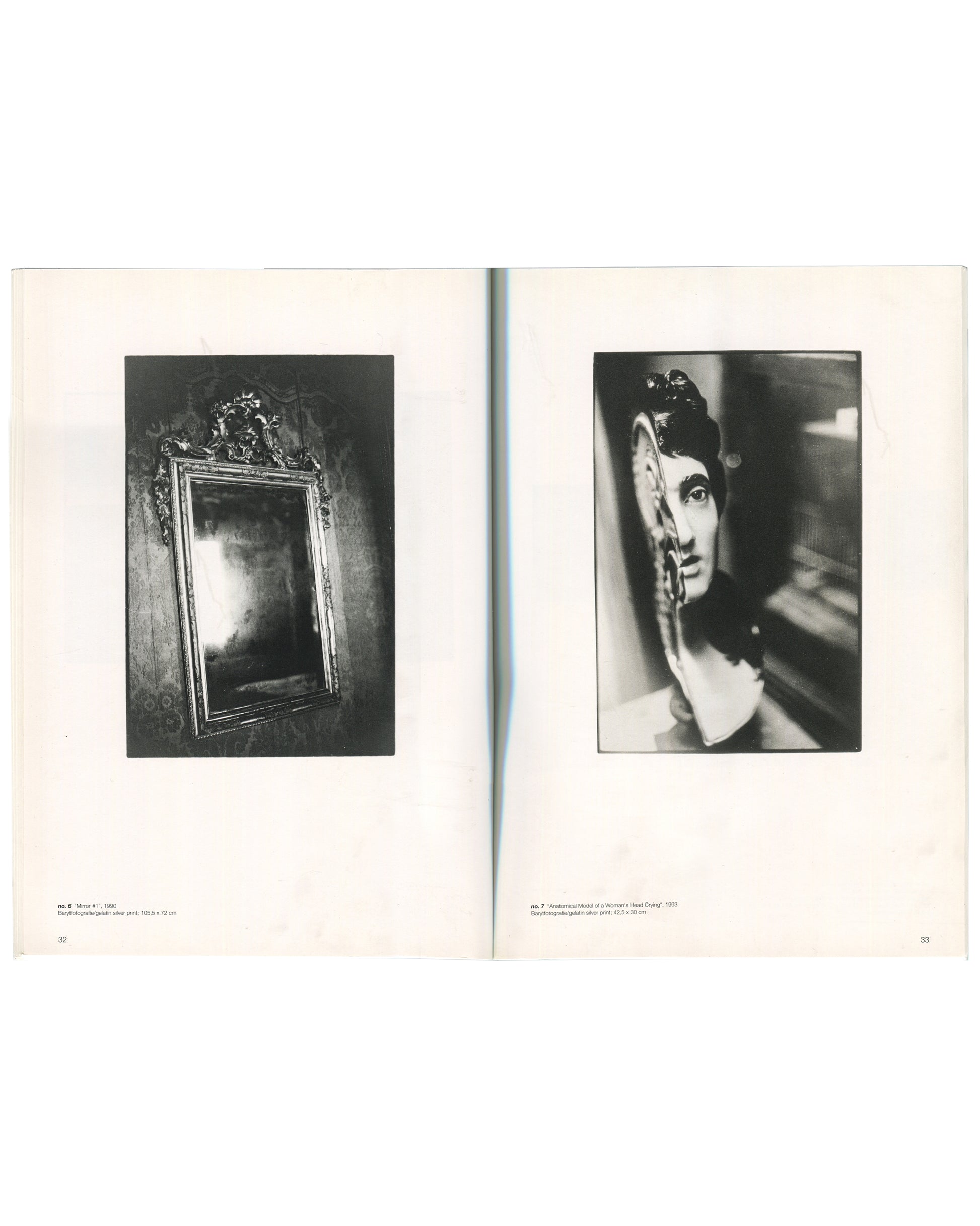 Interior spread of Zoe Leonard, Secession, Wiener Secession, 1997, pages 32–33, left page showing a black-and-white photograph of an ornate gilt-framed mirror reflecting a bright light source captioned "Mirror no. 1, 1990," right page showing a black-and-white photograph of a woman's face reflected in a hand mirror held close to the lens captioned "Anatomical Model at a Woman's Head Crying, 1990."