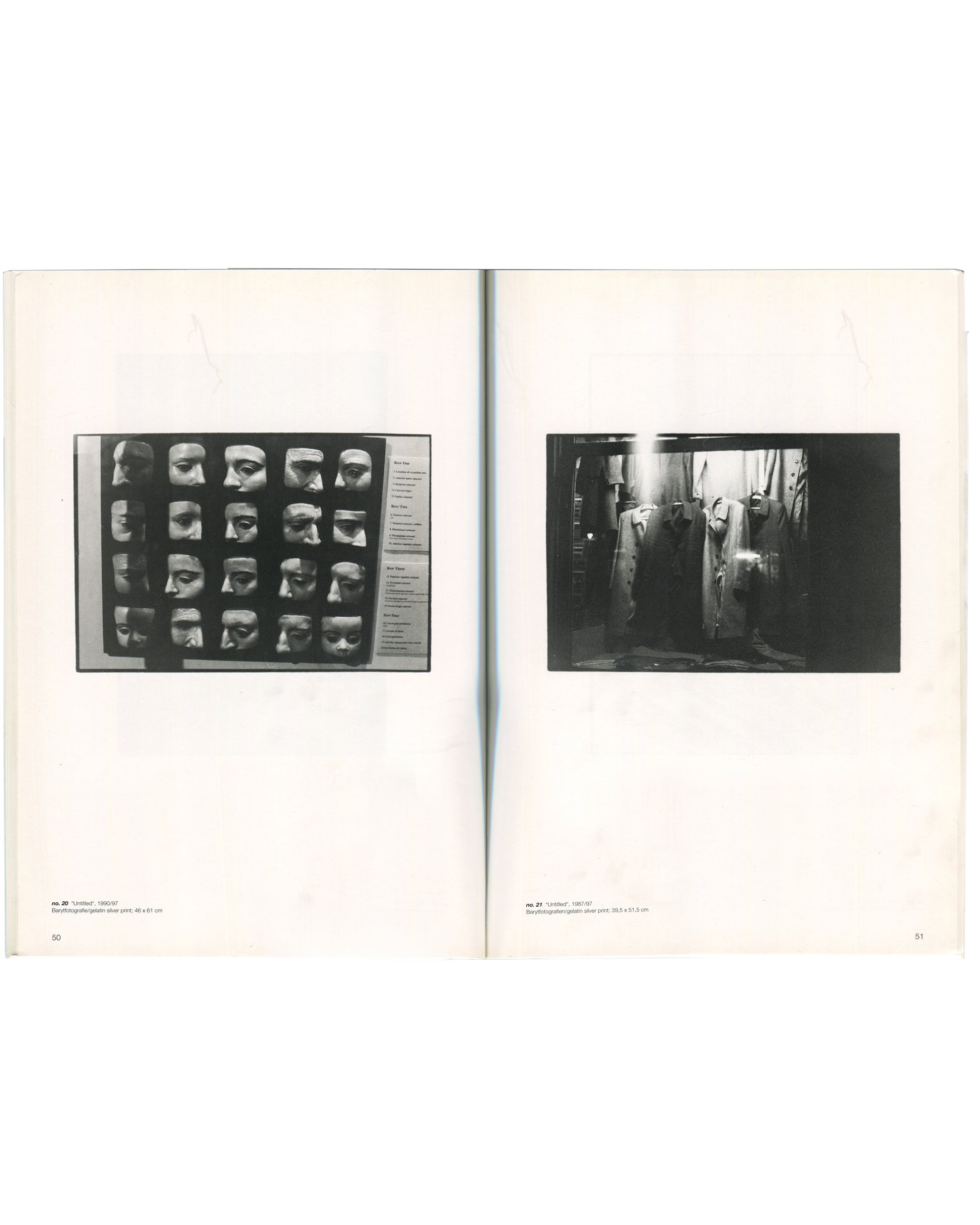 Interior spread of Zoe Leonard, Secession, Wiener Secession, 1997, pages 50–51, left page showing a black-and-white photograph of a grid of plaster face masks mounted on a display board with typed labels captioned "Untitled, 1990–97," right page showing a black-and-white photograph of a dimly lit interior with hanging garments and industrial equipment captioned "Untitled, 1993–97.
