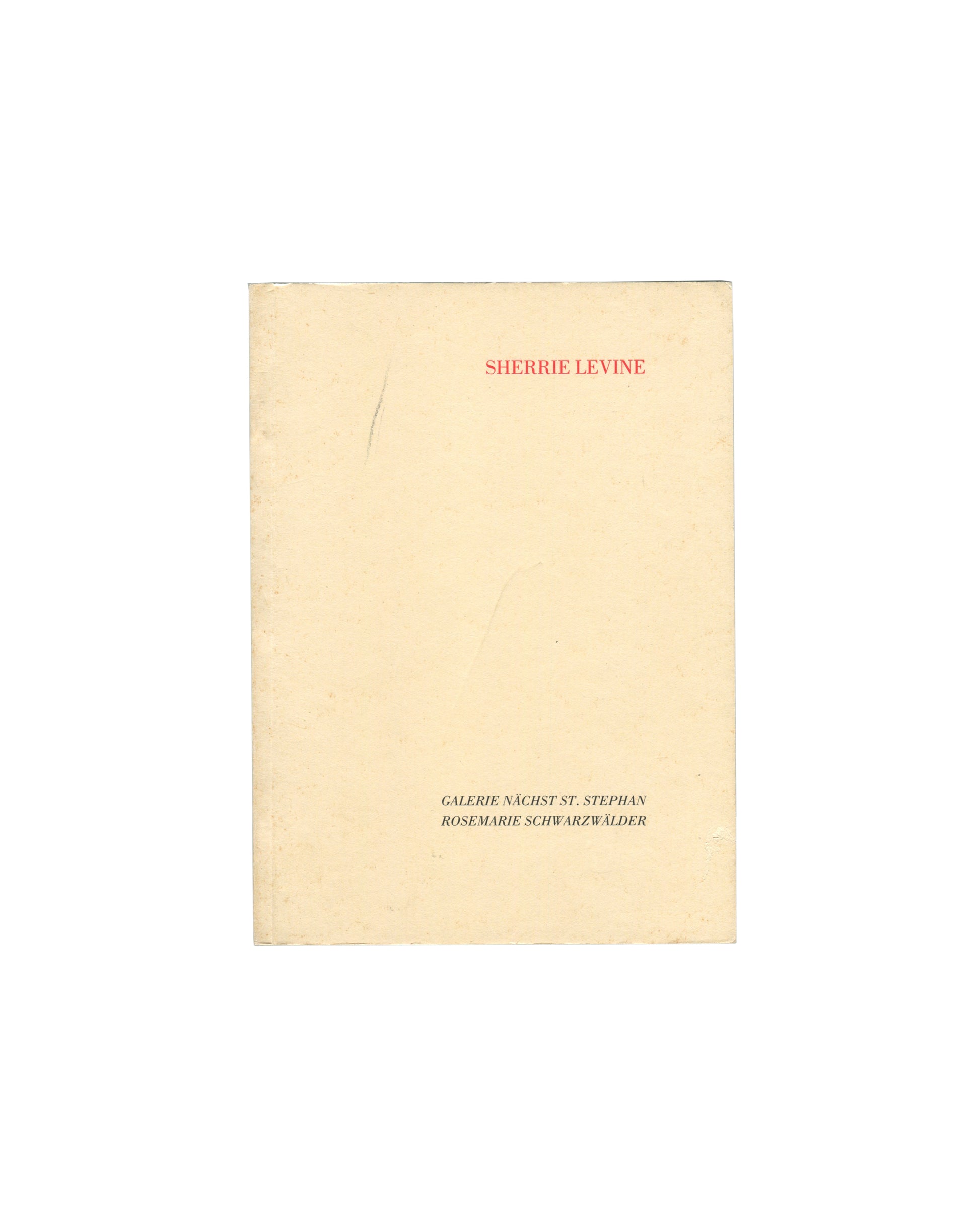 Cover of Sherrie Levine, Galerie nächst St. Stephan Rosemarie Schwarzwälder, Vienna, 1988, showing a plain cream-yellow softcover with SHERRIE LEVINE in small red serif capitals at upper centre and GALERIE NÄCHST ST. STEPHAN / ROSEMARIE SCHWARZWÄLDER in small black serif capitals at lower centre, with a faint vertical pencil mark at left.