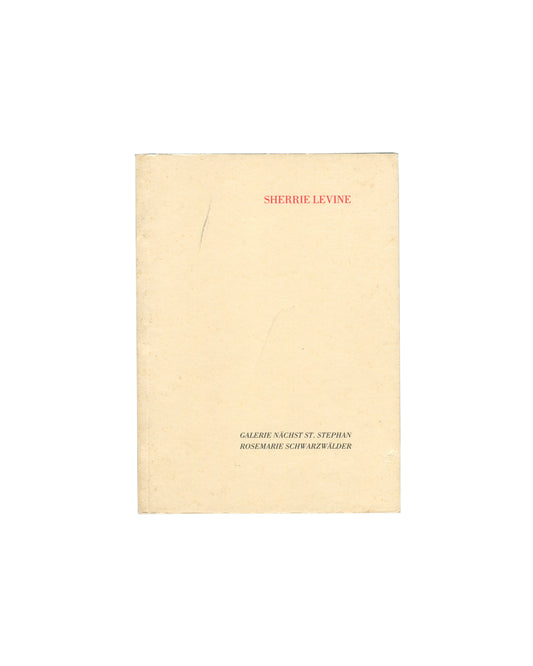Cover of Sherrie Levine, Galerie nächst St. Stephan Rosemarie Schwarzwälder, Vienna, 1988, showing a plain cream-yellow softcover with SHERRIE LEVINE in small red serif capitals at upper centre and GALERIE NÄCHST ST. STEPHAN / ROSEMARIE SCHWARZWÄLDER in small black serif capitals at lower centre, with a faint vertical pencil mark at left.