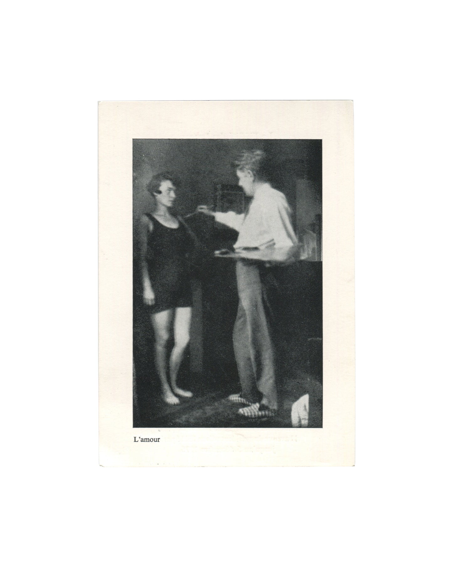 Original 1976 exhibition invitation for René Magritte, La Fidélité des Images, ARC 2, Musée d'Art Moderne de la Ville de Paris, front, showing a black-and-white reproduction of Magritte's photograph L'amour: two figures in an interior, one in a dark swimsuit standing barefoot, the other in a white shirt holding a palette and reaching toward the first, captioned L'amour in small italic type below, on cream card.