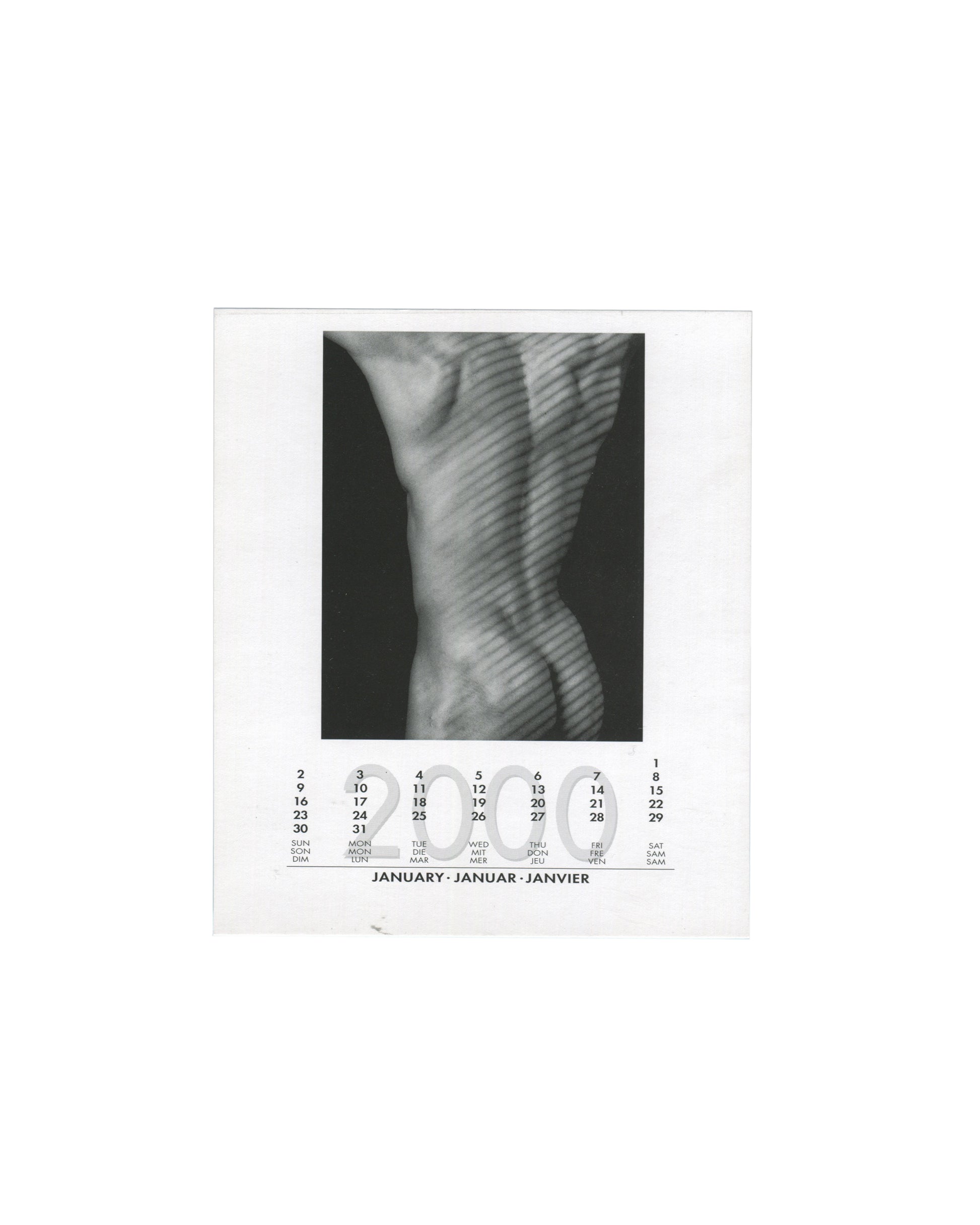 January 2000 card from Robert Mapplethorpe, 2000 Calendar, teNeues, 1999, showing a black-and-white close-up photograph of a male torso from behind, the back and buttocks lit with diagonal striped shadow creating a graphic pattern across the musculature, with the January 2000 calendar grid printed below in English, German, and French.