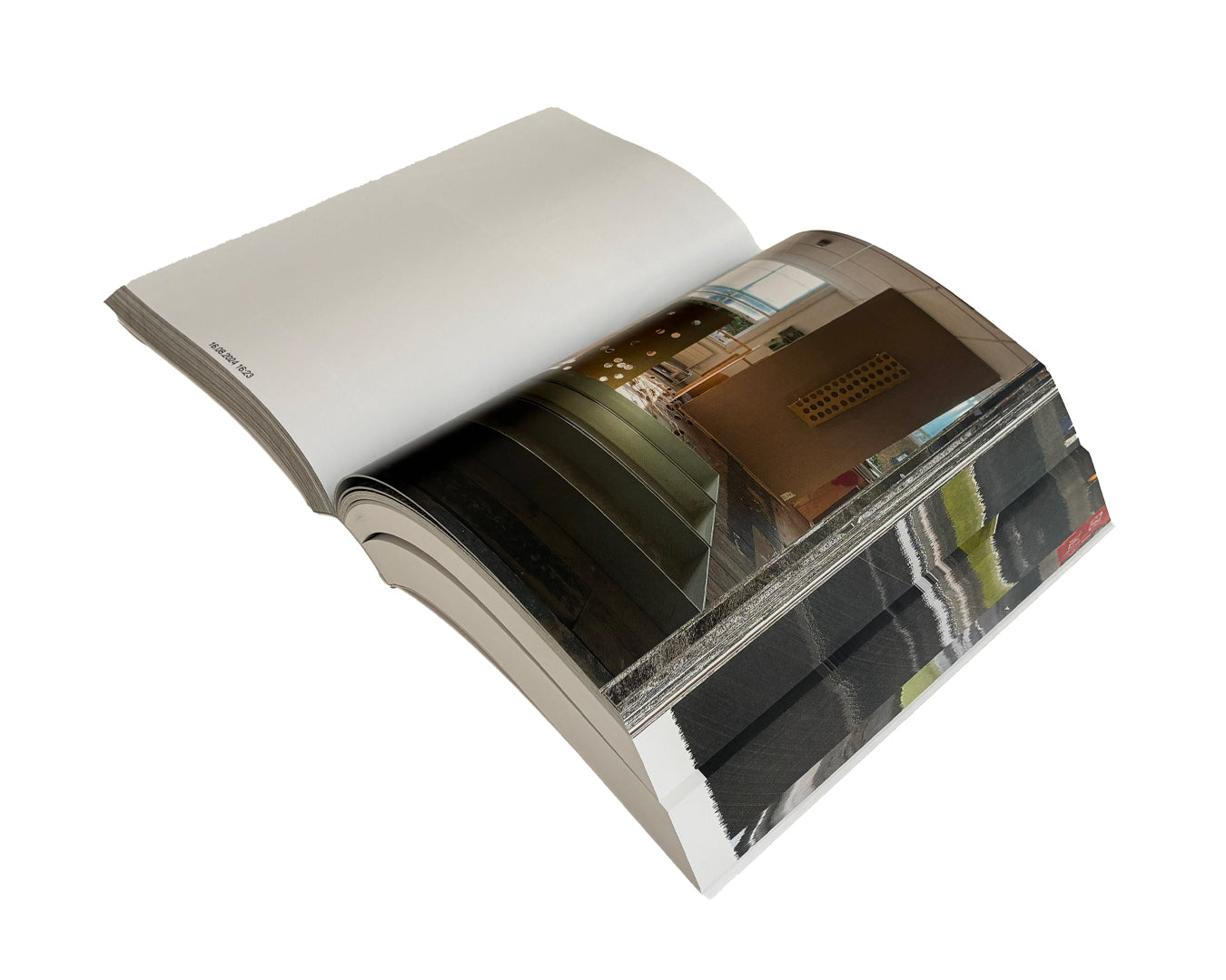 Matthew Peers – Wishing Wells, angled view of open publication showing blank left page with timestamp and full-bleed photograph of sculptural installation with illuminated panels and dark reflective surfaces, right page