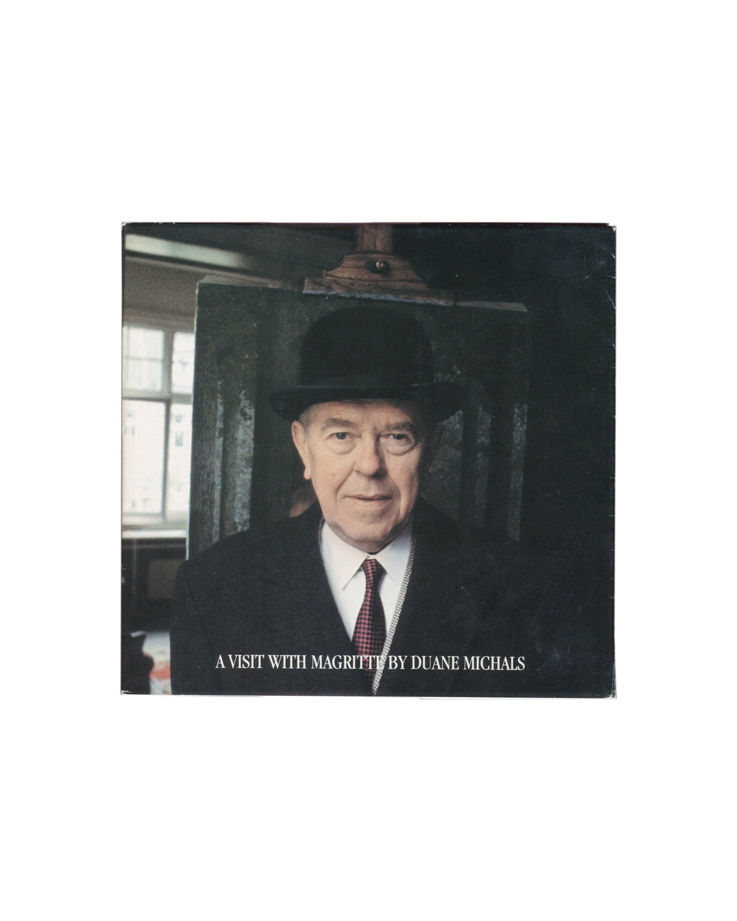 Duane Michals, A Visit with Magritte, Matrix Publications 1981, Magritte in bowler hat before canvas, studio window, front cove