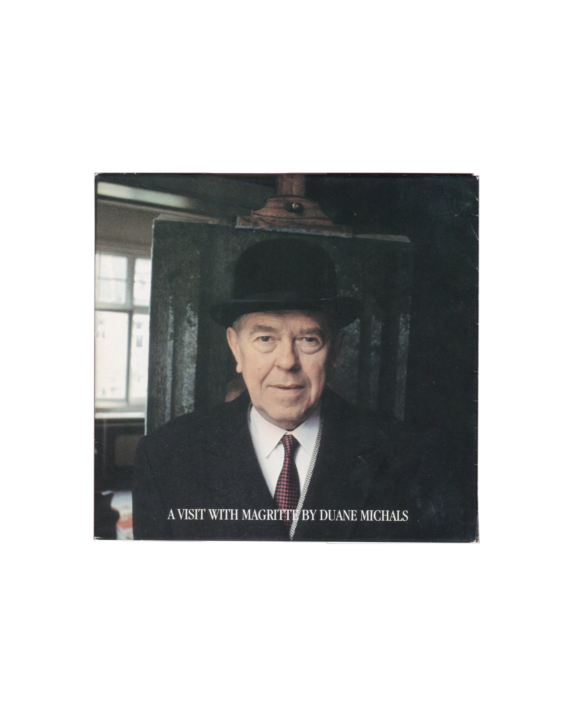 Duane Michals, A Visit with Magritte, Matrix Publications 1981, Magritte in bowler hat before canvas, studio window, front cove