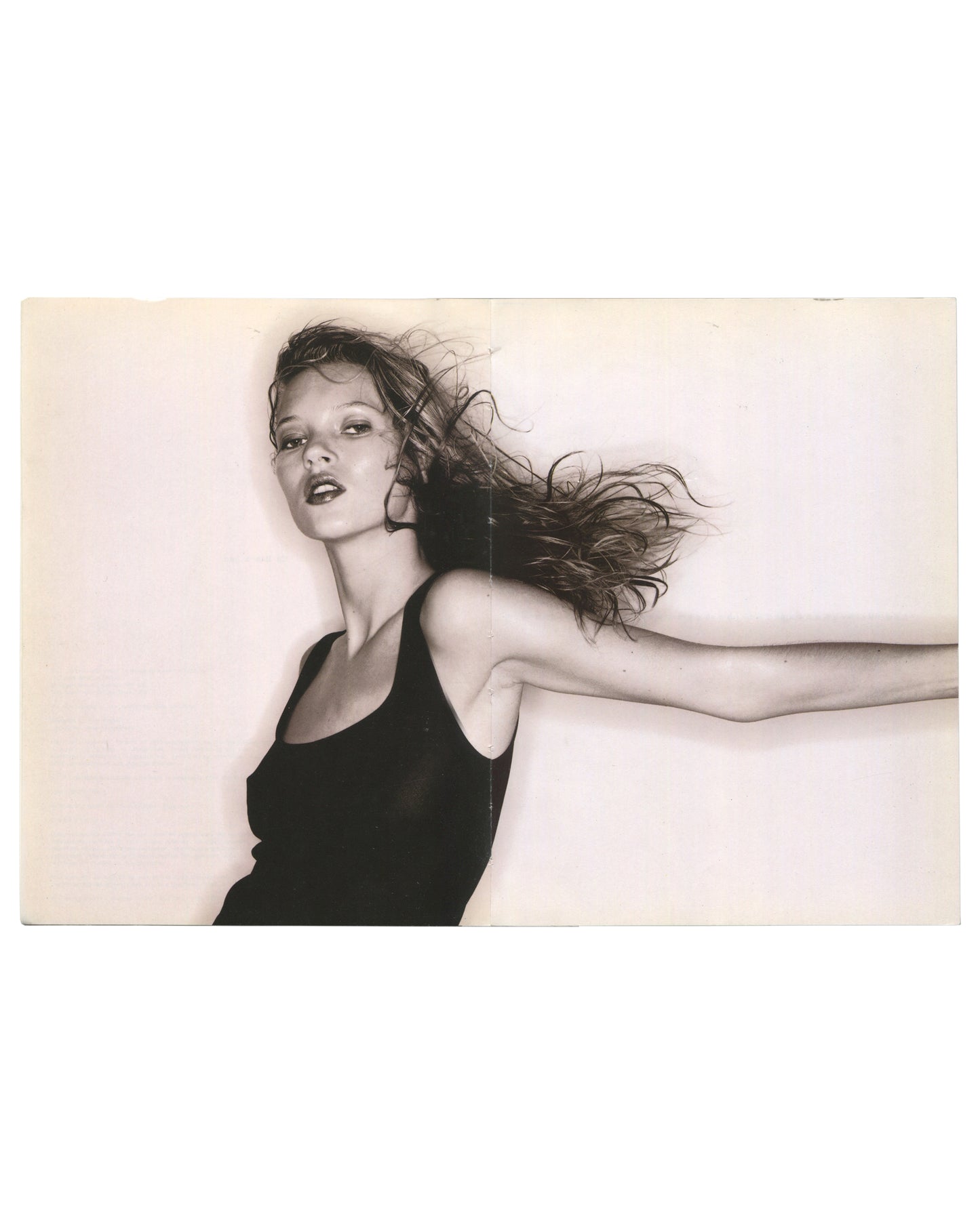 ate Moss, Kate, Pavilion Books Ltd, London, 1997. Interior spread. Left: photographic collage — layered colour fragments including film strips, sky, ocean, geometric shapes, and small fashion images in a loose figurative form. Right: full-bleed colour photograph — Kate Moss waist-deep in turquoise ocean, wet dark hair, direct gaze. Good vintage condition.