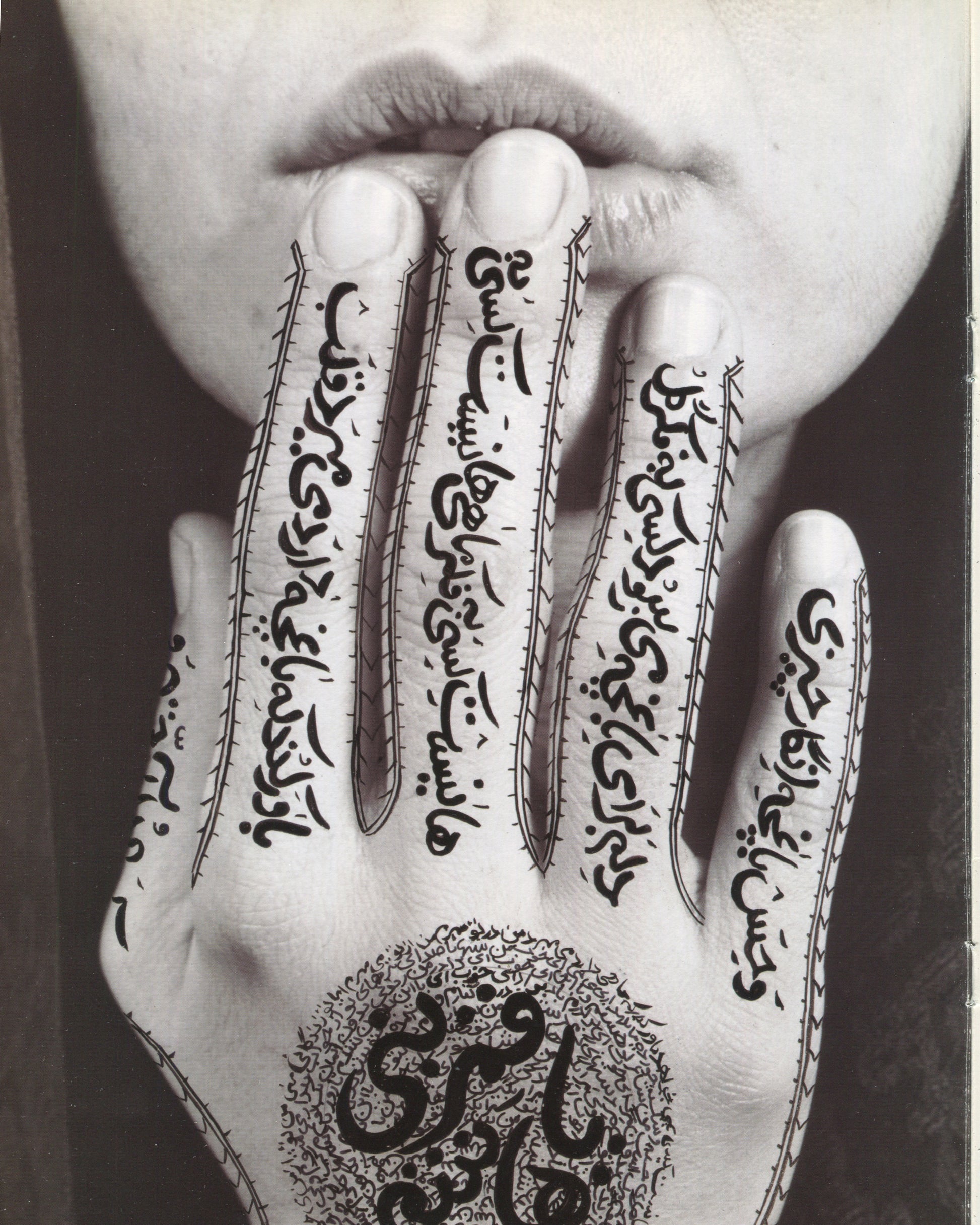 Shirin Neshat, Women of Allah series, hand raised to lips, Persian calligraphy covering fingers and palm 
