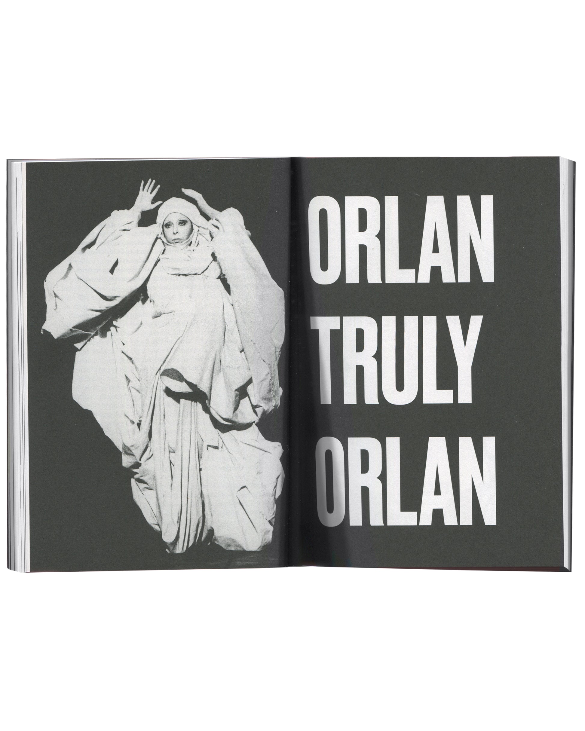 ORLAN, Strip-Tease, 2024, interior spread, ORLAN in white draped costume, chapter title "ORLAN TRULY ORLAN" in white on dark ground