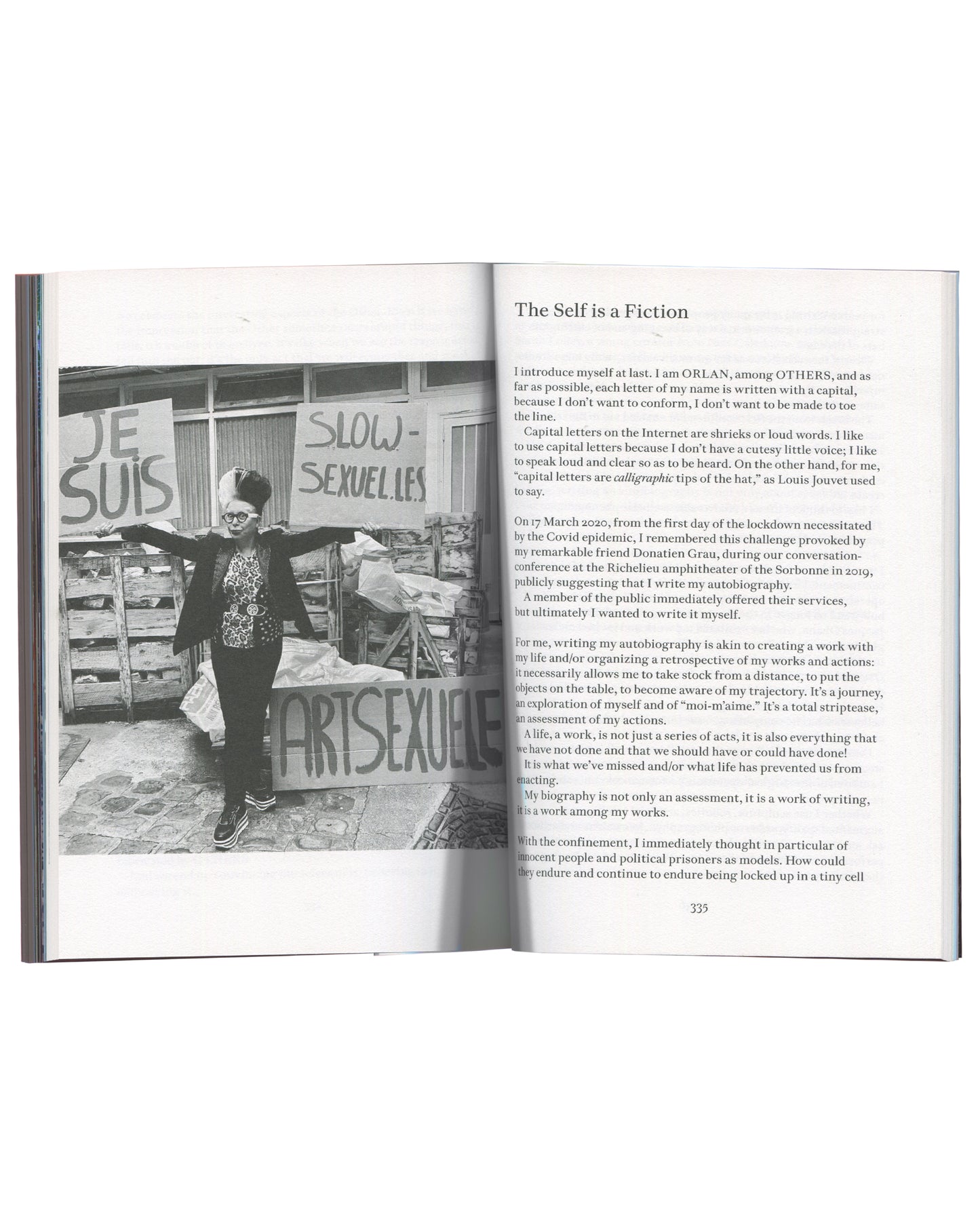 ORLAN, Strip-Tease, 2024, interior spread p.335, ORLAN at protest holding signs, chapter "The Self is a Fiction"