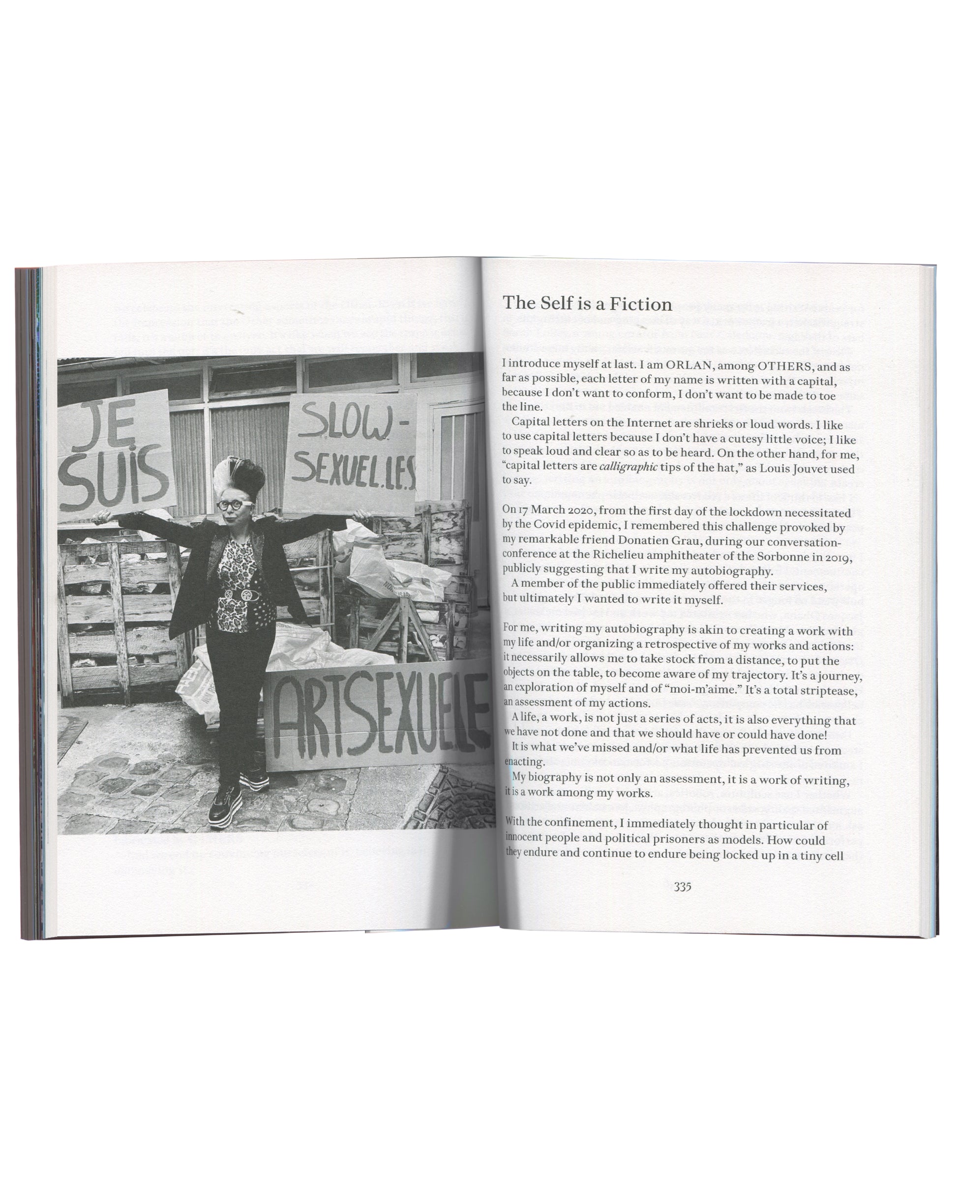 ORLAN, Strip-Tease, 2024, interior spread p.335, ORLAN at protest holding signs, chapter "The Self is a Fiction"