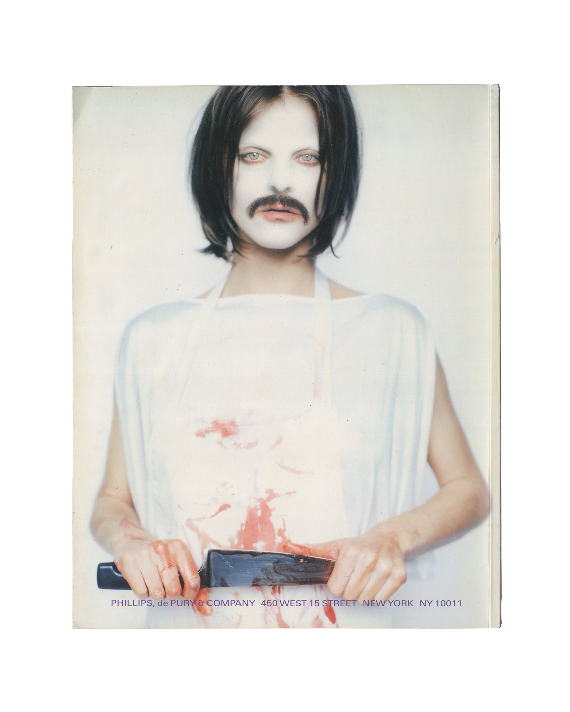 THE NEW RARE EDITIONS — Record: June 6, 2005. 2005 / 2008 / 2026. Auction catalogue back cover, Phillips de Pury & Company, Contemporary Art: Including Prints, Photographs & Multiples, New York, 6 June 2005; 76 pp. Full-bleed colour photograph — figure in white draped garment, white face paint, dark bob wig and painted moustache, holding a dark object at waist height; red paint or simulated blood across torso and hands; direct frontal gaze; white ground. Lower edge: black sans-serif — 'PHILLIPS, de PURY & C