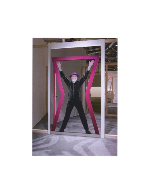 Front 2023 Galleria Continua invitation for Michelangelo Pistoletto, Segno Arte, Paris, front, colour photograph of Pistoletto in black outfit and purple hat, arms raised, legs spread, standing inside a large magenta-pink frame structure whose diagonal struts form an X around his body, in a gallery or fair space.