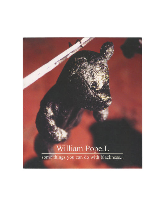 William Pope.L — some things you can do with blackness…, Kenny Schachter Rove, London, 2005. Front cover. Deep red ground. Centre: close-up photograph of a small black bear-like sculptural object, heavily textured surface with white dust or residue, suspended or resting against two white diagonal rods. White serif title text lower centre: "William Pope.L / some things you can do with blackness…"