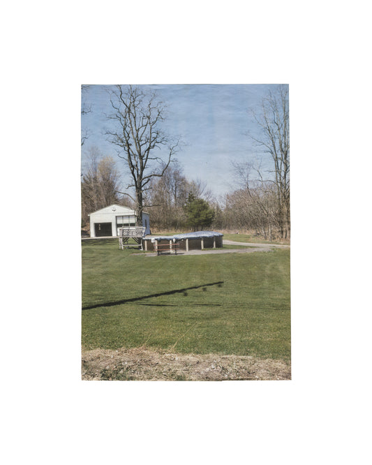 Folded artist publication/poster, Richard Prince, 3rd Place, Point d'Ironie no. 39, Agnès b. / Point d'Ironie, Paris, April 2006. Ed. Hans Ulrich Obrist. Offset on lightweight paper. Front face: colour photograph — rural American landscape, open green lawn, white garage structure, bare trees, blue sky; diagonal shadow across grass foreground. Light handling and original fold lines, good vintage condition.

