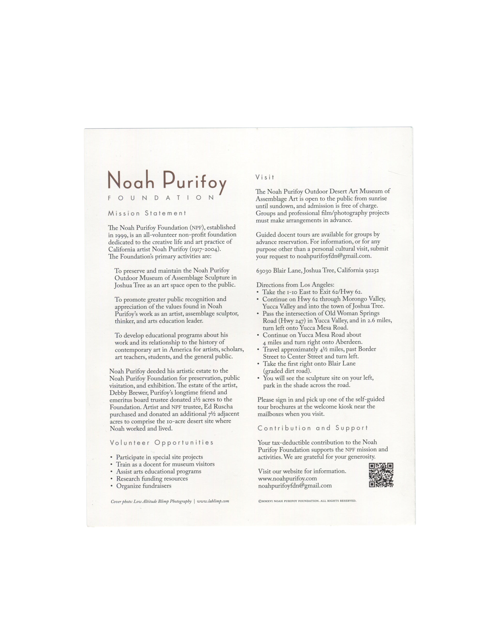 Noah Purifoy Foundation museum brochure, Joshua Tree, c. 2022, reverse panel, white ground with Noah Purifoy / FOUNDATION in brown serif and spaced caps at upper left; mission statement and foundation history in two columns; Volunteer Opportunities bullet list; at right Visit panel with opening hours, free admission, address, directions from Los Angeles, Contribution and Support section with QR code, and website www.noahpurifoy.com.