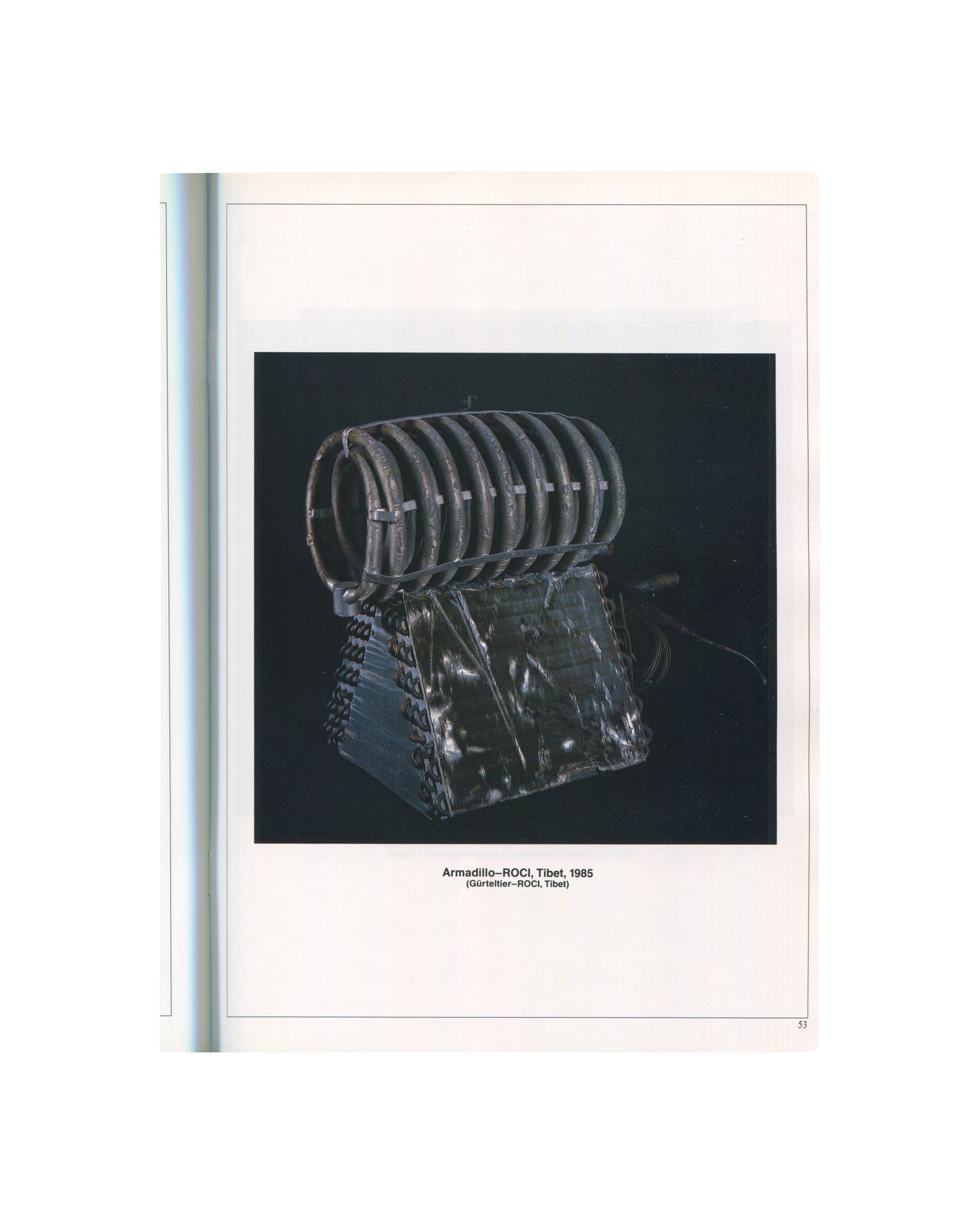ROCI interior p.53. Armadillo–ROCI Tibet, 1985 — coiled dark metal rings above wedge base, black ground.