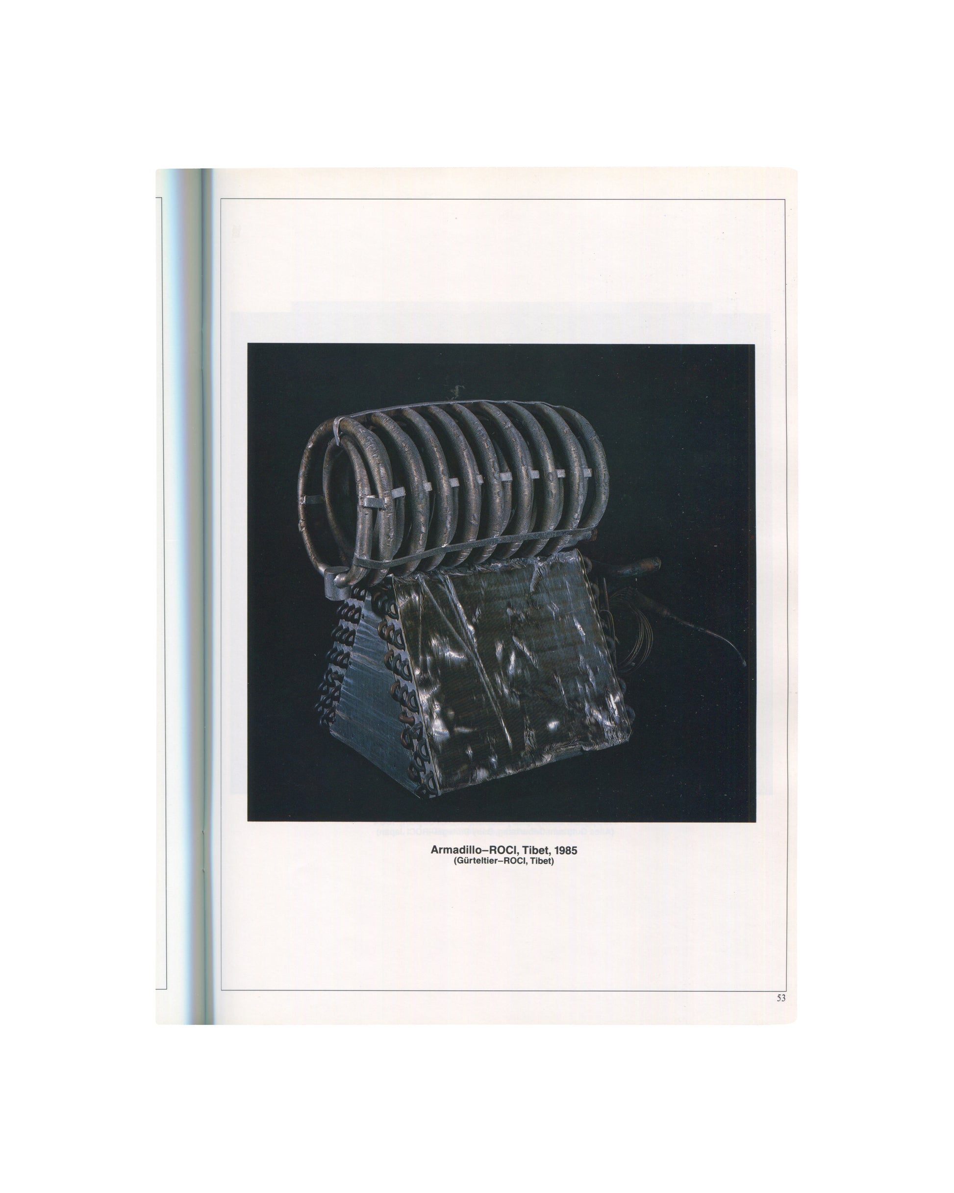 ROCI interior p.53. Armadillo–ROCI Tibet, 1985 — coiled dark metal rings above wedge base, black ground.