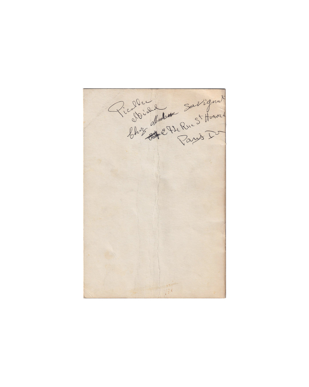 Rear wrapper, Roy Lichtenstein catalogue, Galerie Ileana Sonnabend, Paris, 1965. Plain cream paper, unprinted. Handwritten ink inscription in cursive at upper centre reading approximately: [Picallce?] Michel / chez Madame Savignat / 274 Rue St Honoré / Paris Ier. First word partially illegible. Vertical use fold running full length of wrapper. General age toning and handling wear.