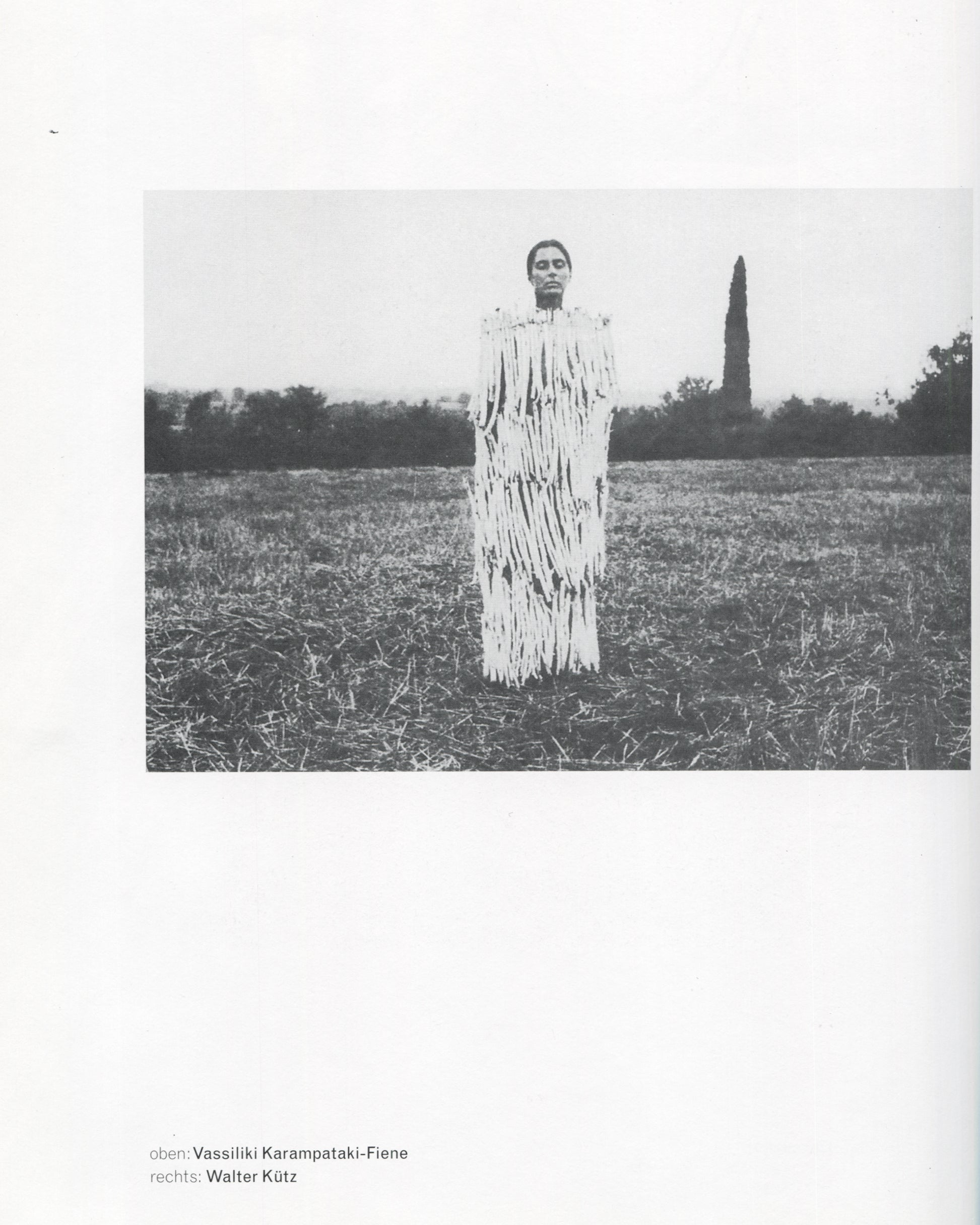 Klaus Rinke, Saldo, Rinke Klasse 1997, Vassiliki Karampataki-Fiene, figure in shredded white costume standing in harvested field, b&w