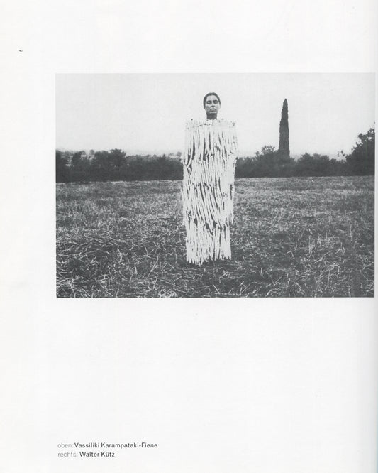 Klaus Rinke, Saldo, Rinke Klasse 1997, Vassiliki Karampataki-Fiene, figure in shredded white costume standing in harvested field, b&w