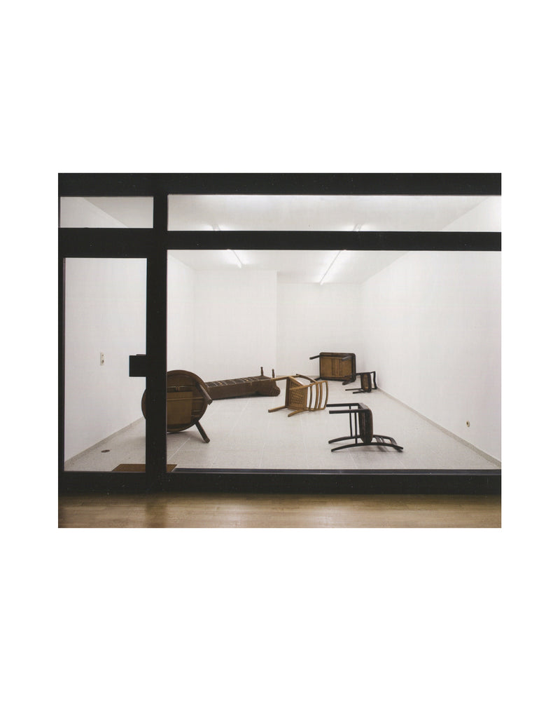 Gregor Schneider, Double, 2011, interior, gallery through dark frame, scattered dark wooden furniture pieces on white floor 