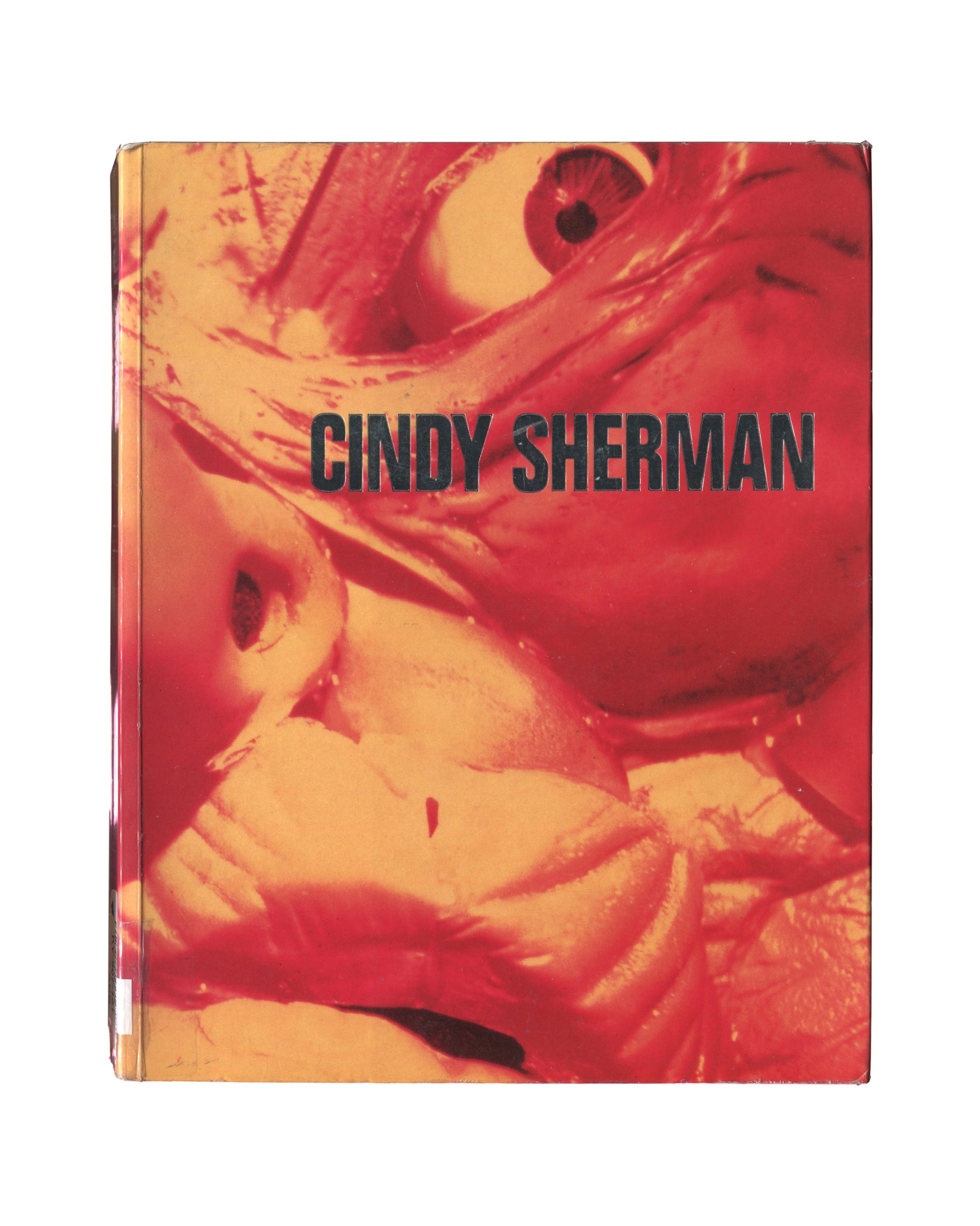Cindy Sherman, Photographic Work 1975–1995, Schirmer/Mosel 1995, front cover: colour Untitled — Sherman seated in black-and-white striped dress, tousled hair, dark ground; pronounced fading and colour shift from ex-library circulation